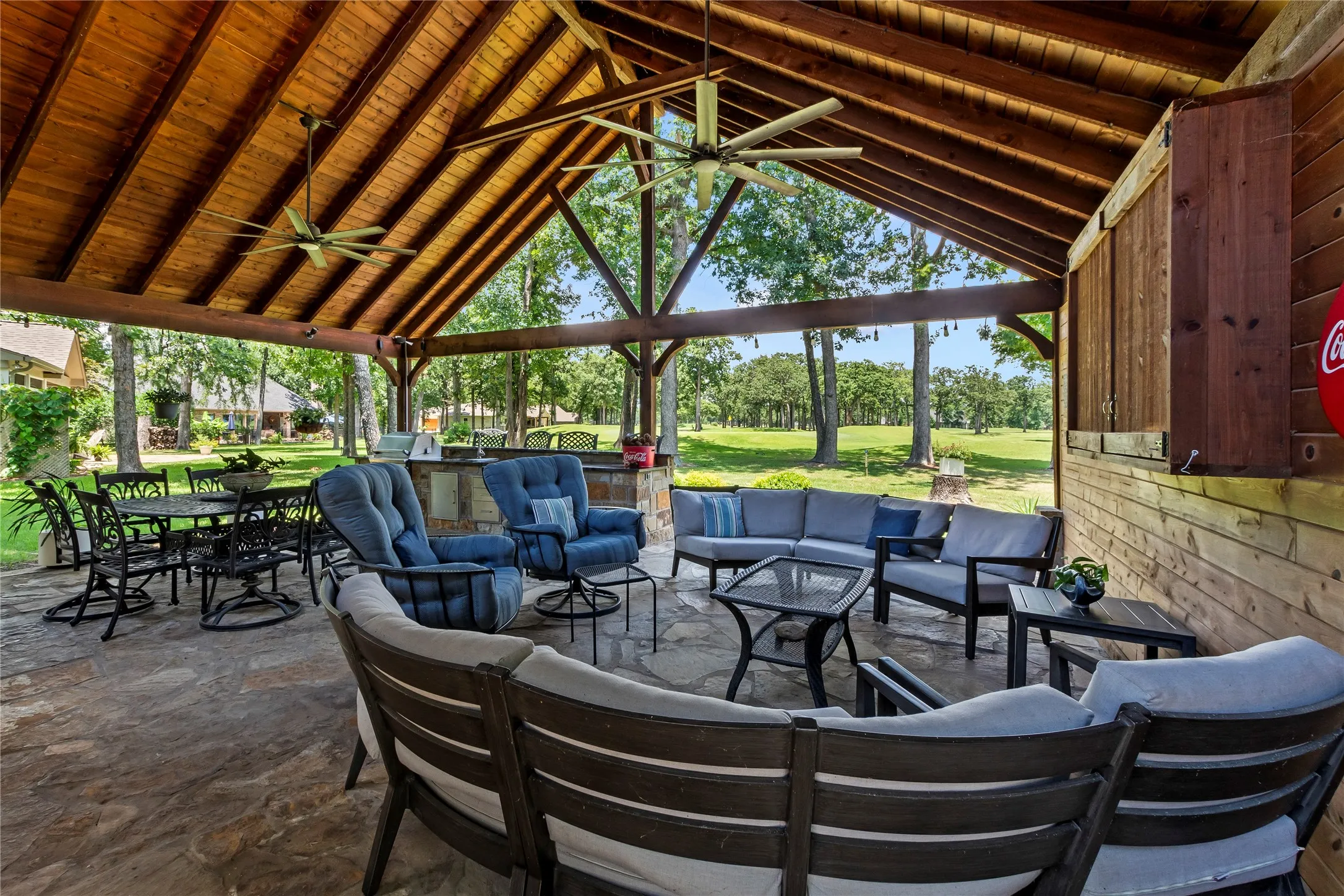 Covered patio with outdoor kitchen and TV area.