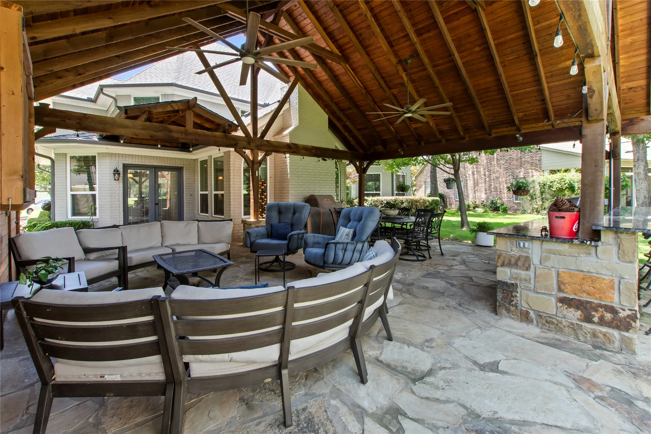 Covered patio with outdoor kitchen and TV