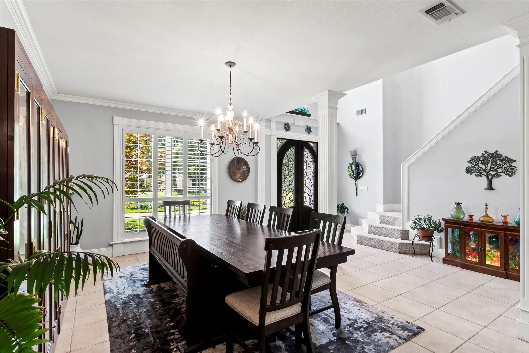 Open formal dining area with plantation shutters and lots of natural light.