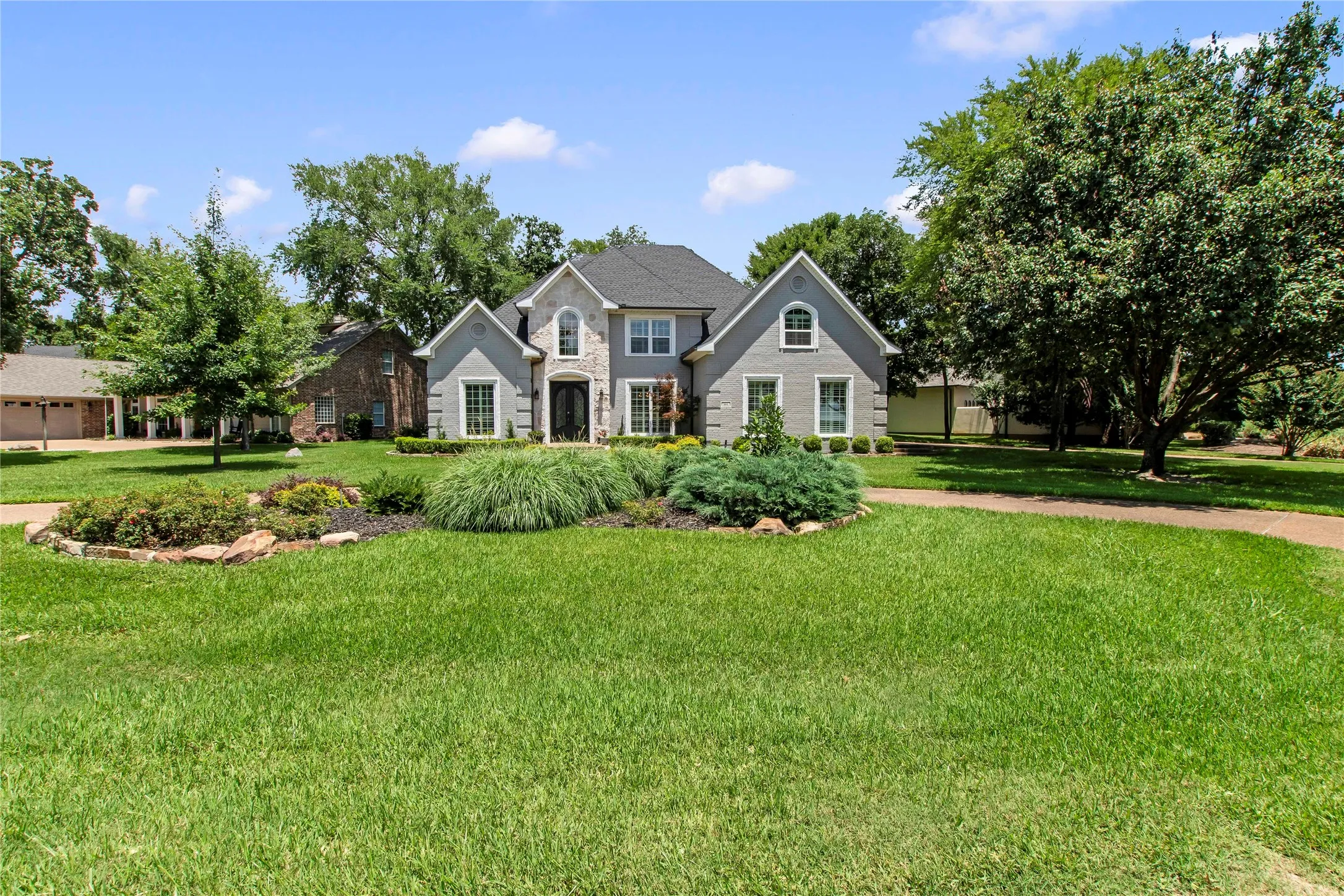 Front of house from the road with circle driveway.