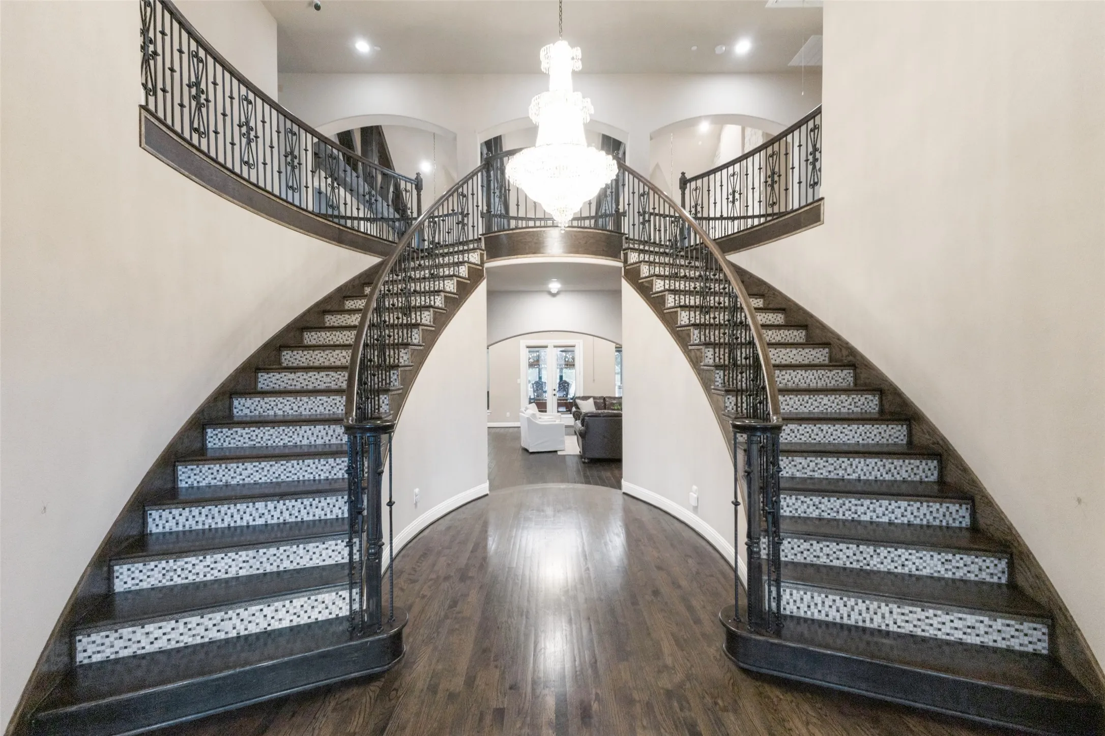 Dual staircase with wood steps and tiled risers.