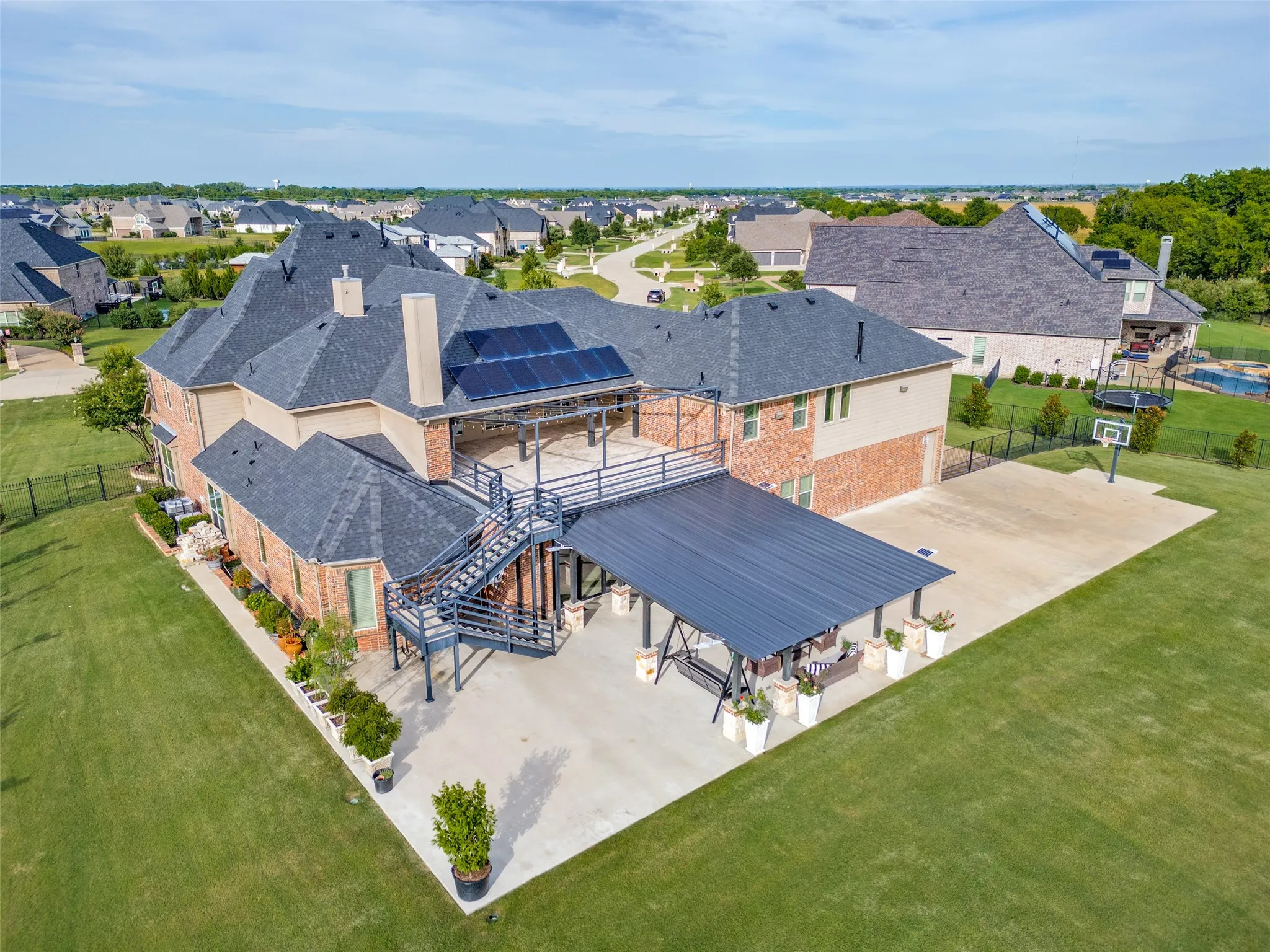 This estate was specifically designed for outdoor entertaining!Covered patio with complete outdoor kitchen.  Extended flat work on both sides of the patio.  Second floor covered balcony with open air patio extension just off of the game room.