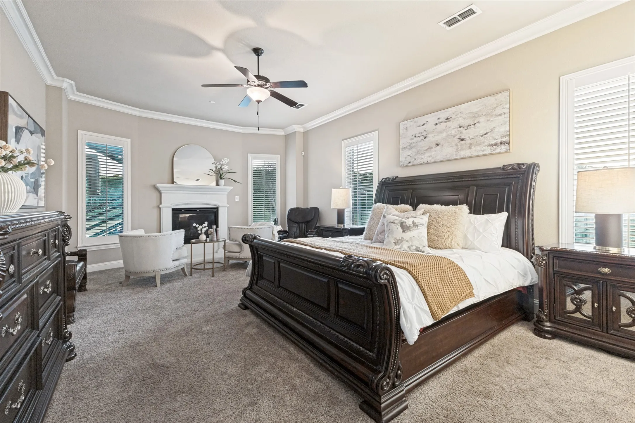 Spacious primary bedroon with bay window, sitting area dn gas fireplace.