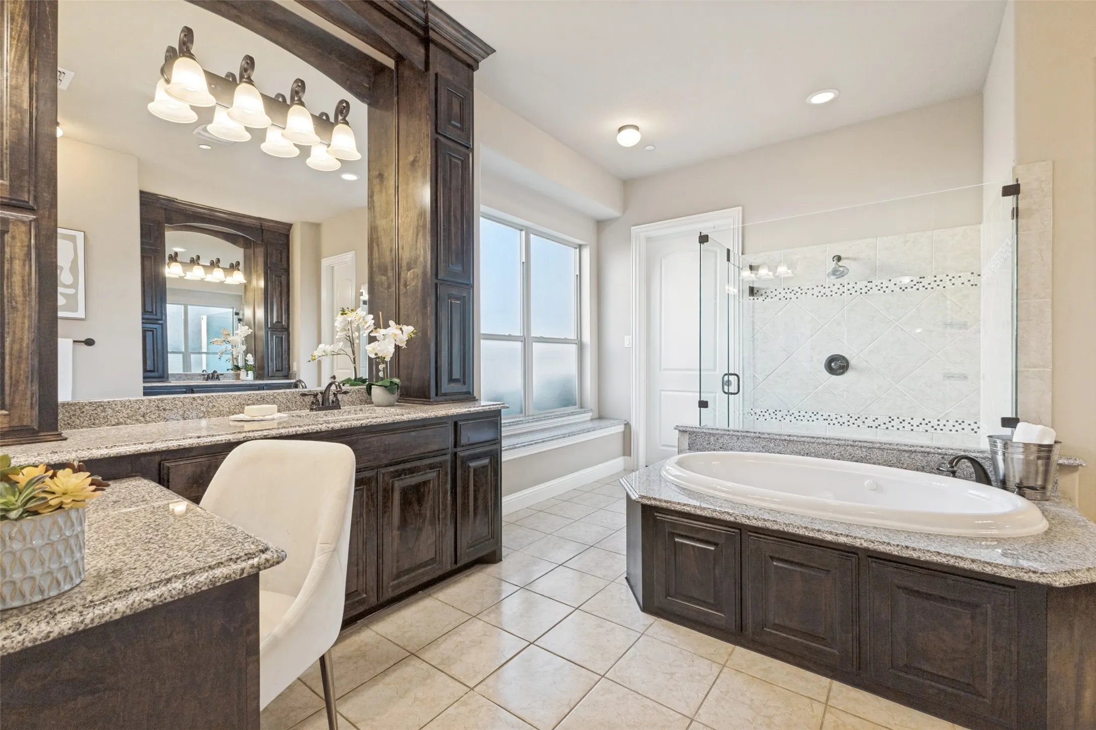 Completely upgraded primary bath with dual vanaties, a make-up area, large garden tub and separate shower.