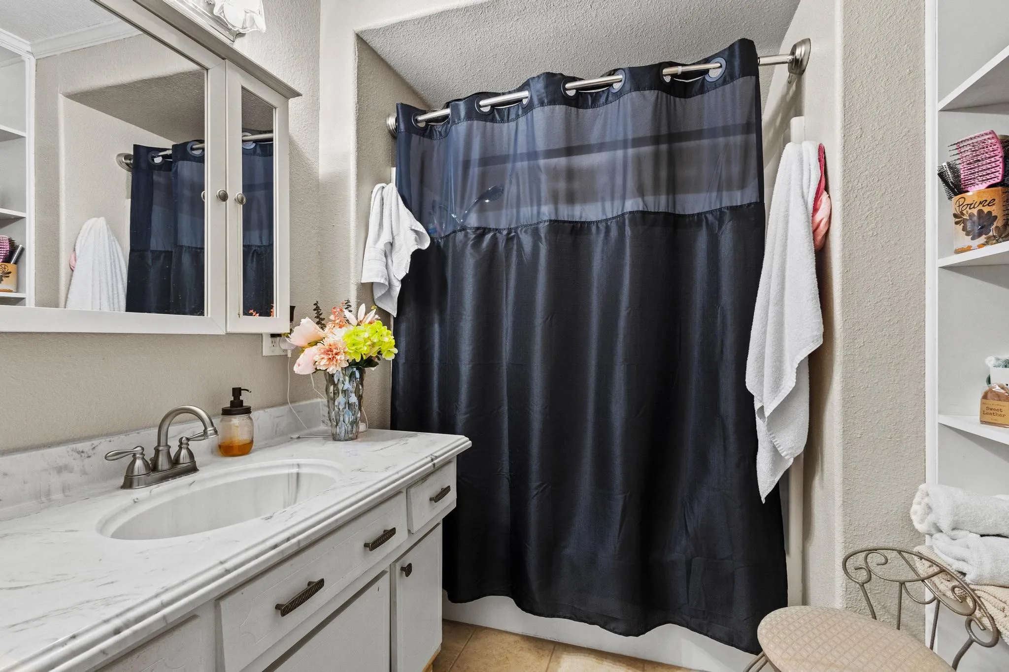 Full size bathroom with built in cabinets and shower/bathtub combo
