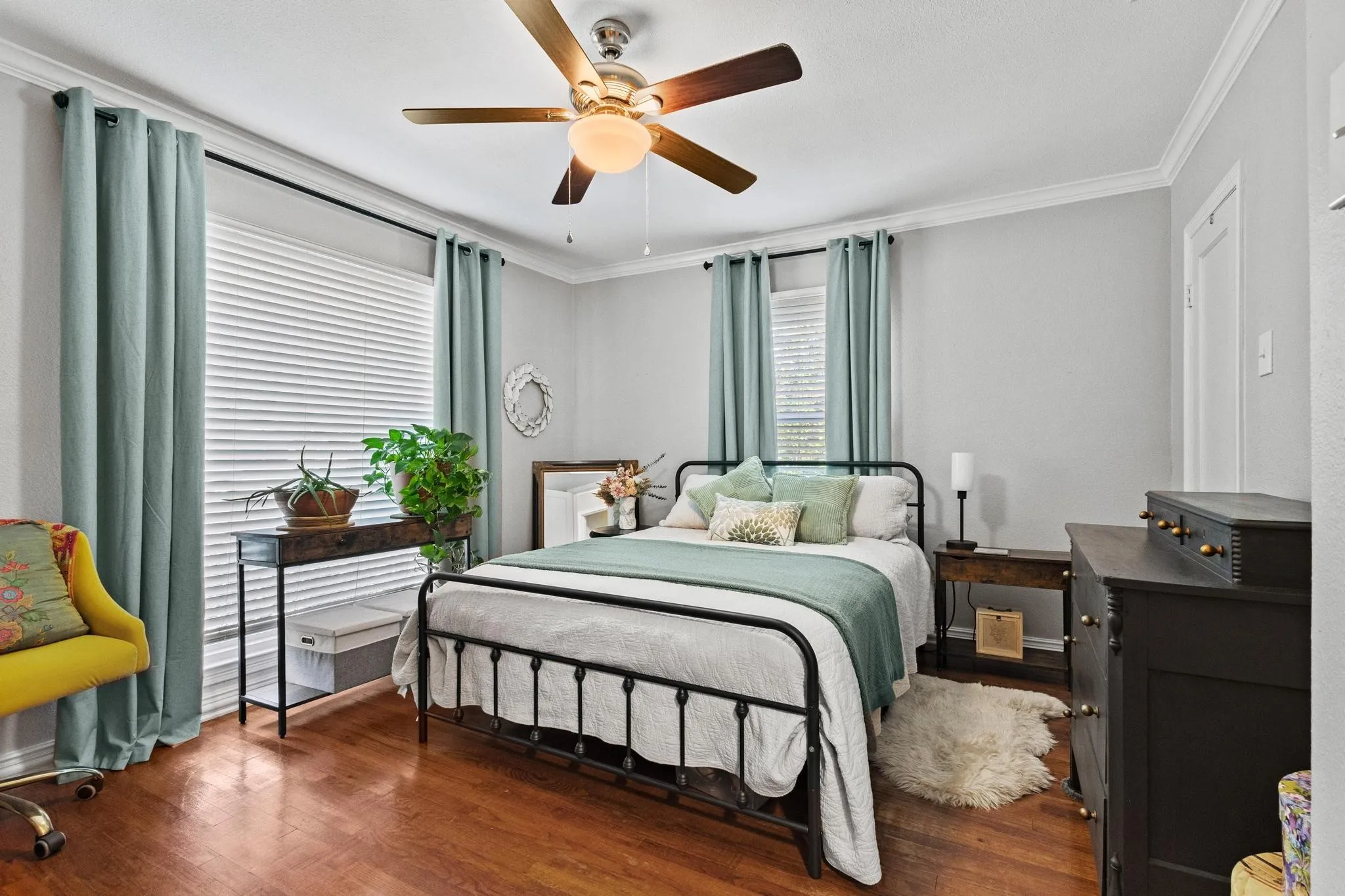 Large bedroom with natural light and hardwood flooring throughout