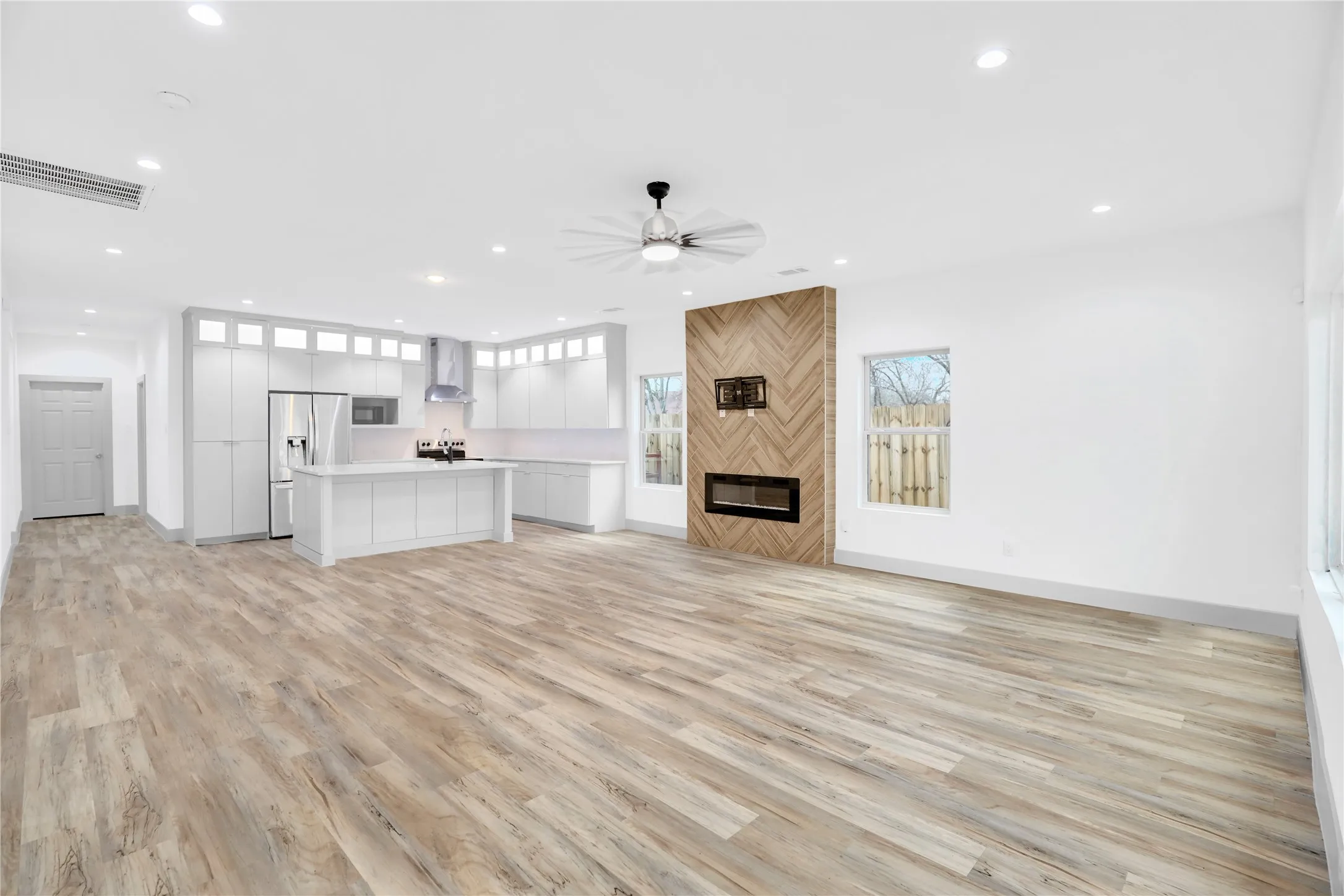 Open-concept living area featuring wood-finish flooring throughout