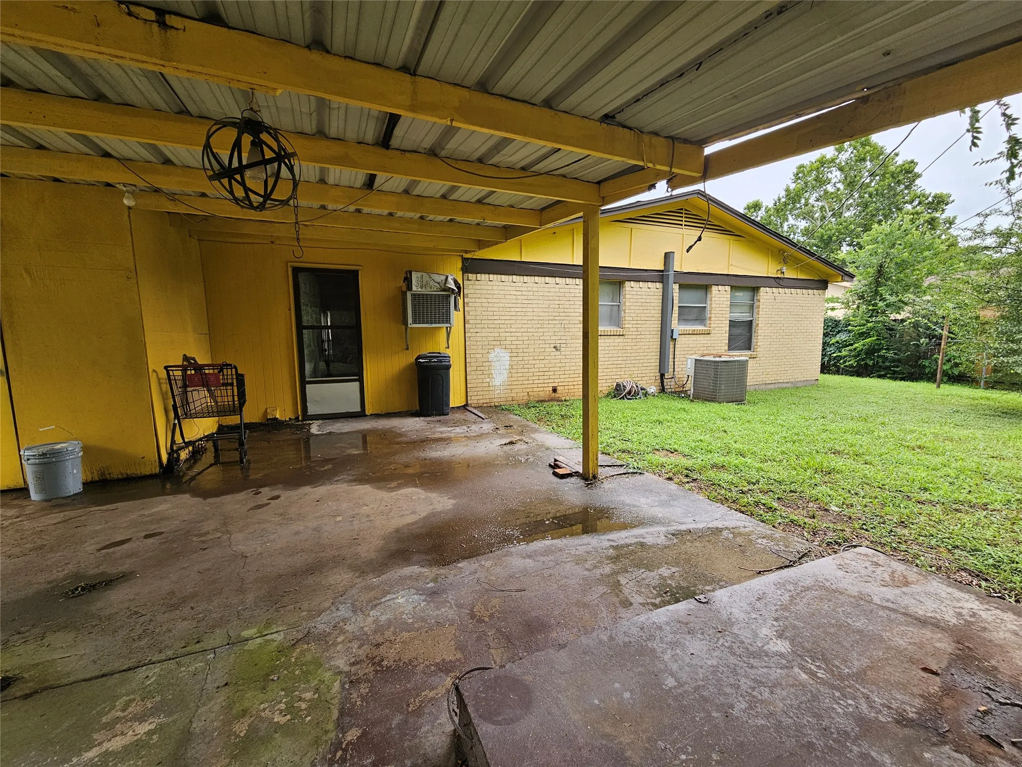 Covered patio with storm shelter visible (do NOT enter)