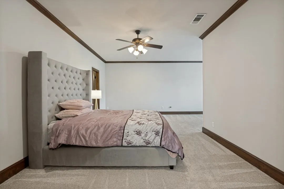 Spacious room featuring vaulted ceilings with a ceiling fan, recessed lighting, and crown molding