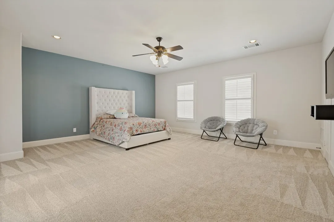 Spacious room featuring broadloom carpeting, recessed lighting, and a ceiling fan