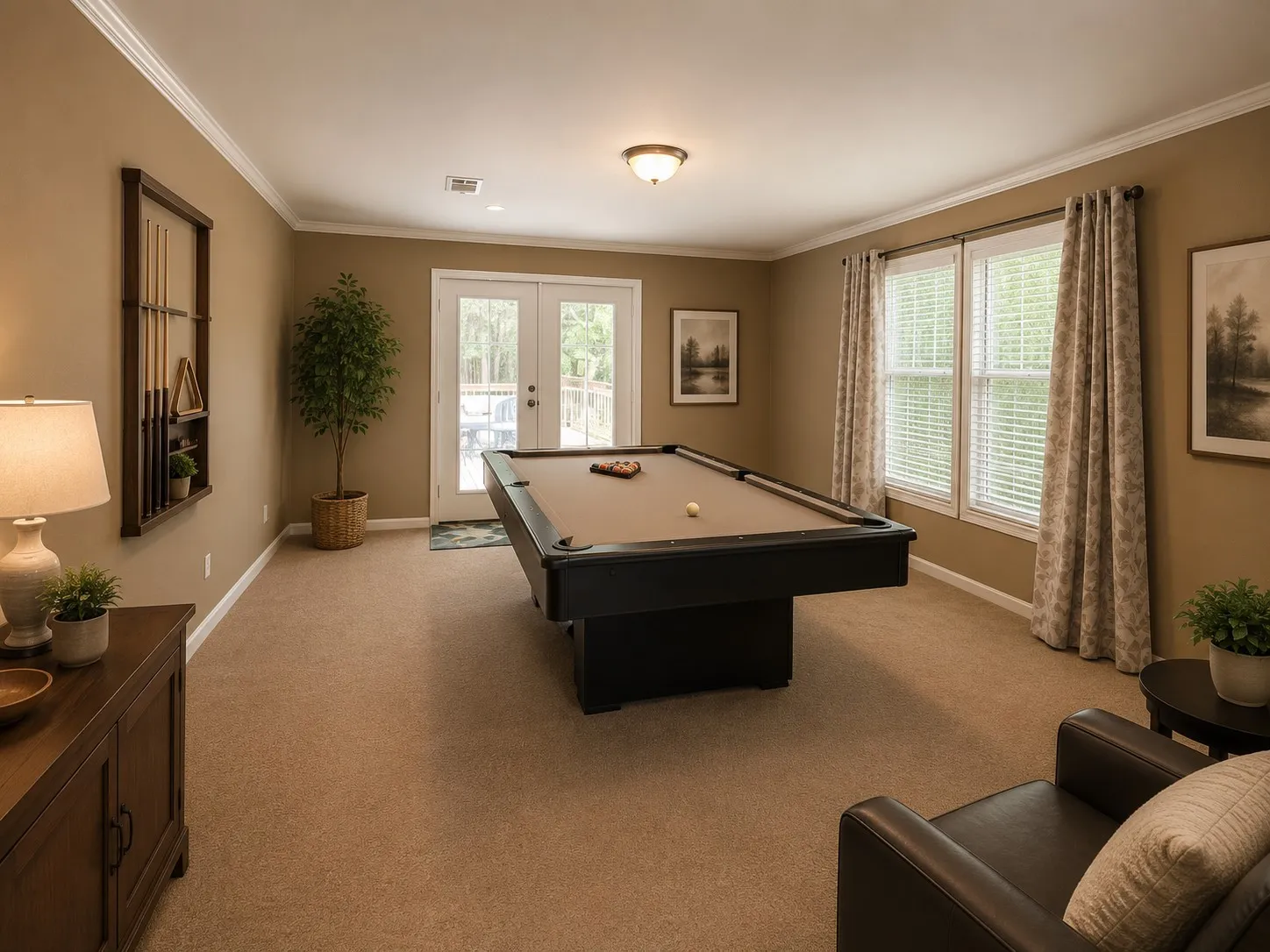 Spacious recreation room featuring neutral carpeting and crown molding