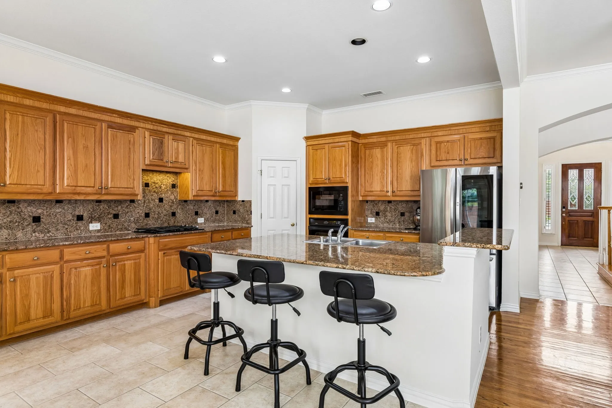 Indulge in the culinary delight of the chef's kitchen, where a spacious eat-in island takes center stage, inviting you to gather and create cherished memories in this open and generously proportioned space.