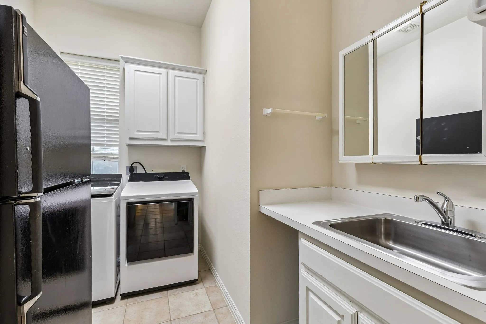 The laundry room everyone loves. Room for washer, dryer and an extra fridge. Sink and abundant cabinetry included. Oh yeah!!