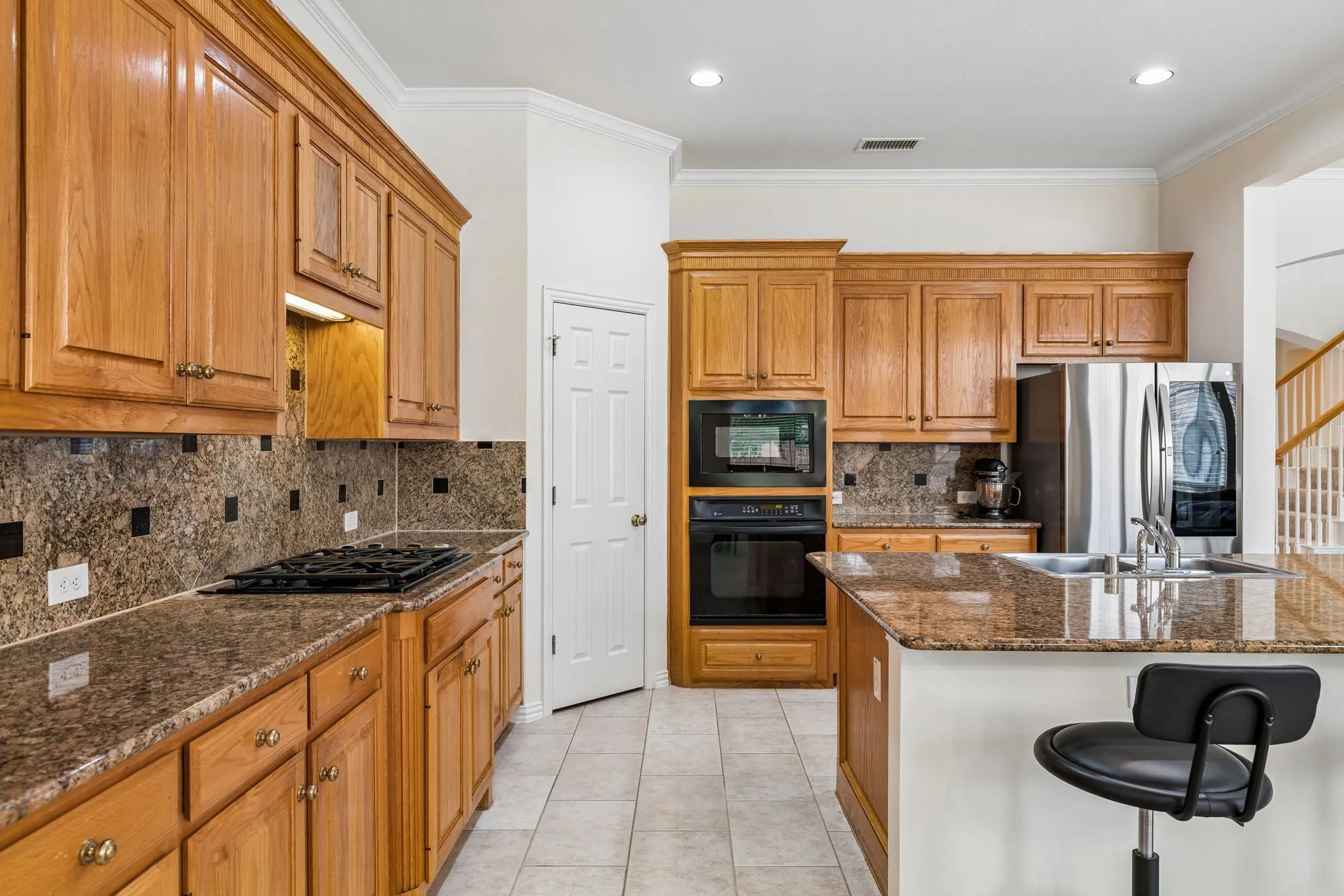 A gourmet kitchen that will no doubt inspire your inner chef with its gorgeous counters, ample cabinets, stainless steel appliances, gas stovetop, walk-in pantry and island.