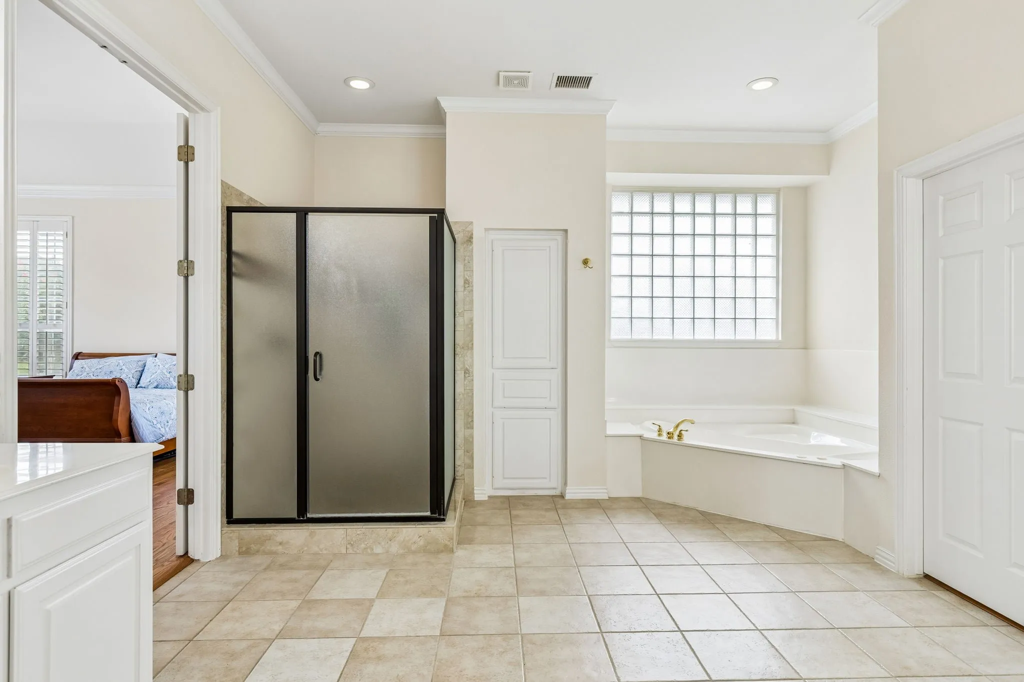 A soothing tub invites relaxation, while the separate shower adds a touch of everyday luxury. Spacious, refined, and thoughtfully designed, this is the perfect place to begin and end each day.