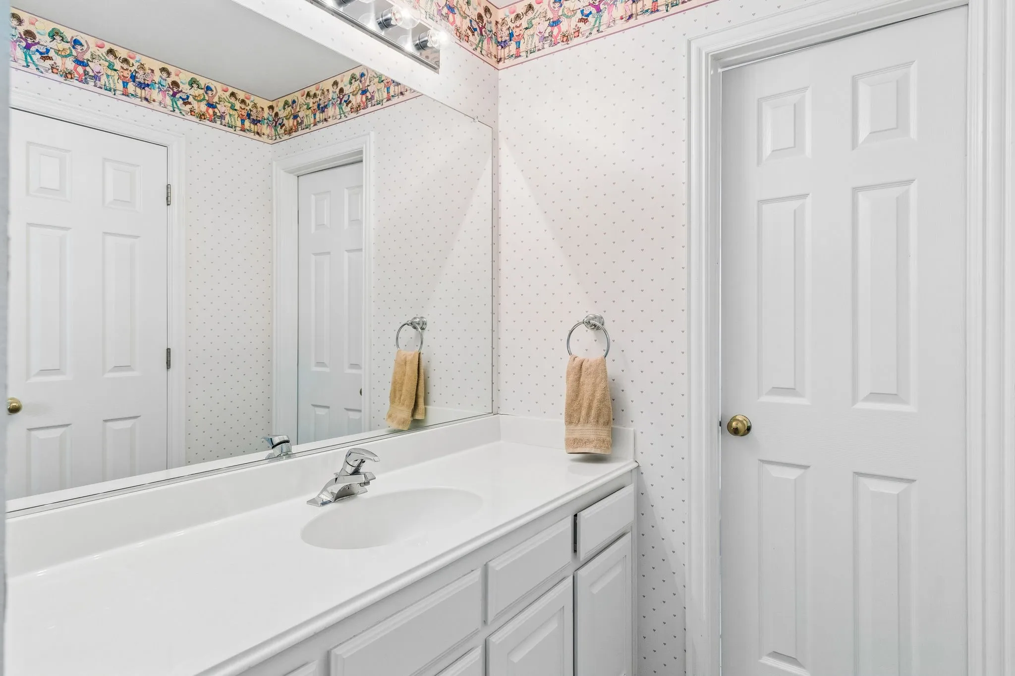 A full bath on the second level with a tub/shower combination, vanity, and ample storage cabinetry.