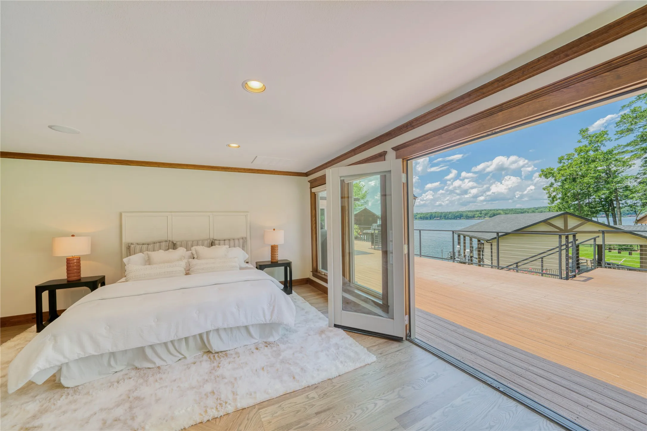 Main House - Primary Bedroom-Open and Airy-Lakeside views and access. Auto Blinds