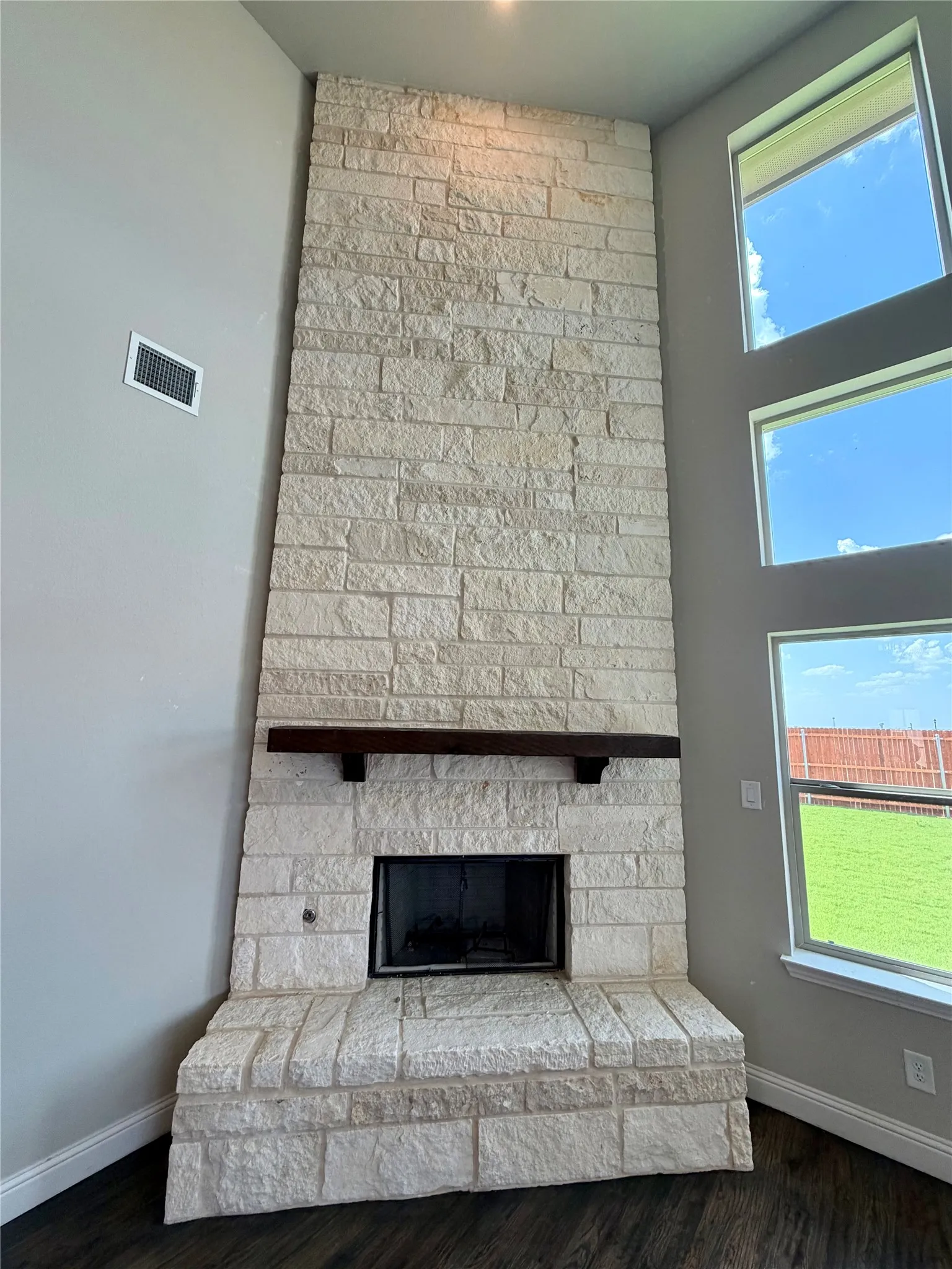 20 ft stone, raised hearth fireplace with stained cedar mantle