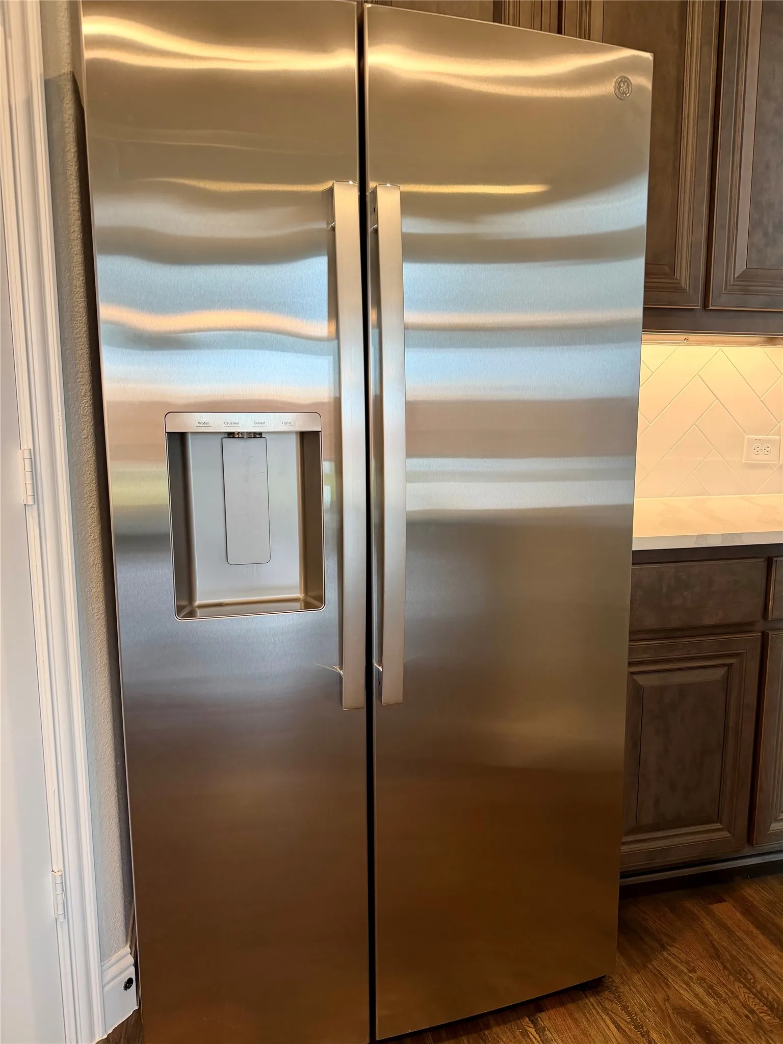 This home actually comes with a new side by side stainless GE fridge with ice maker in the door!
