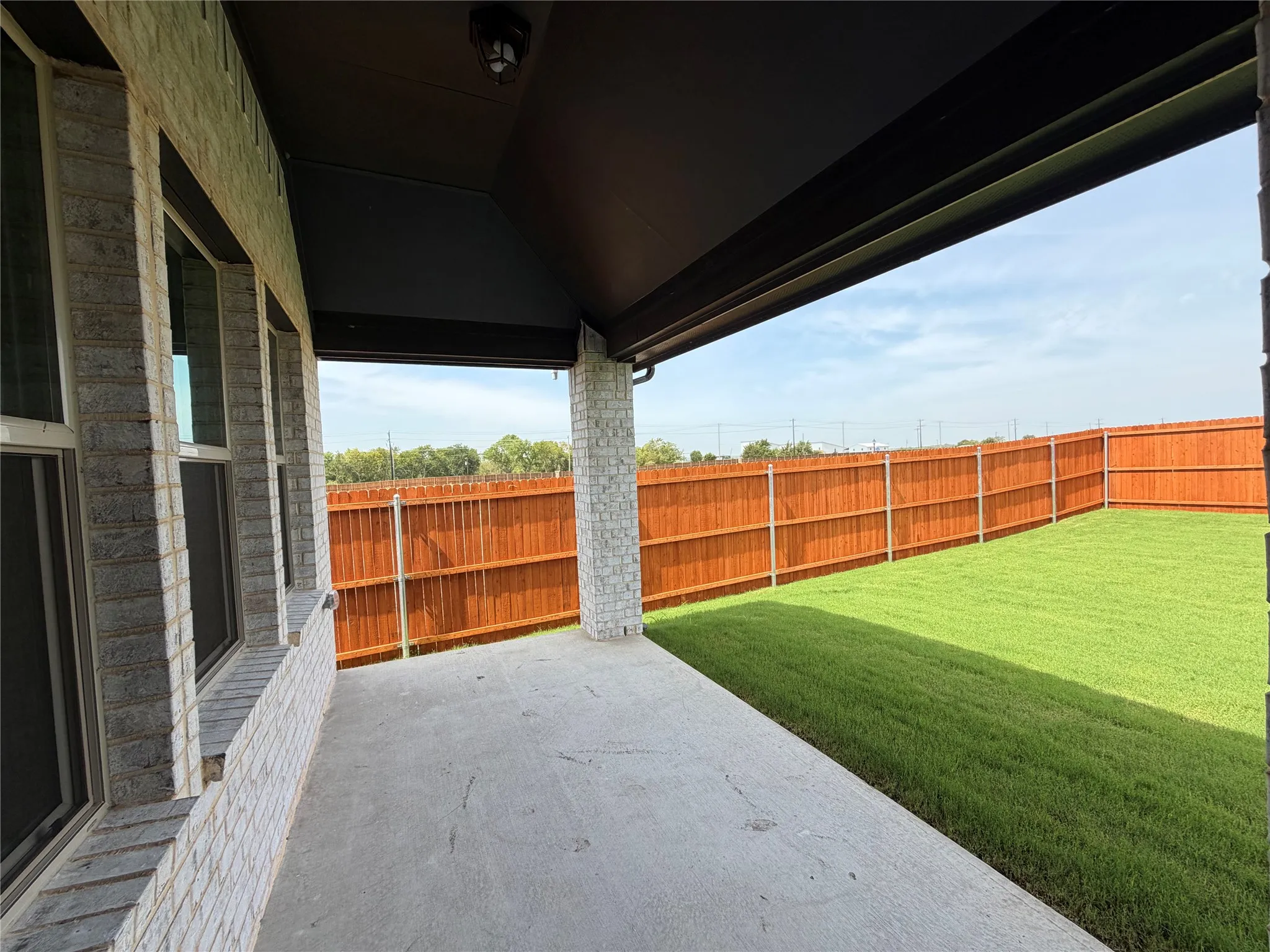 Serene covered patio for relaxing and grilling