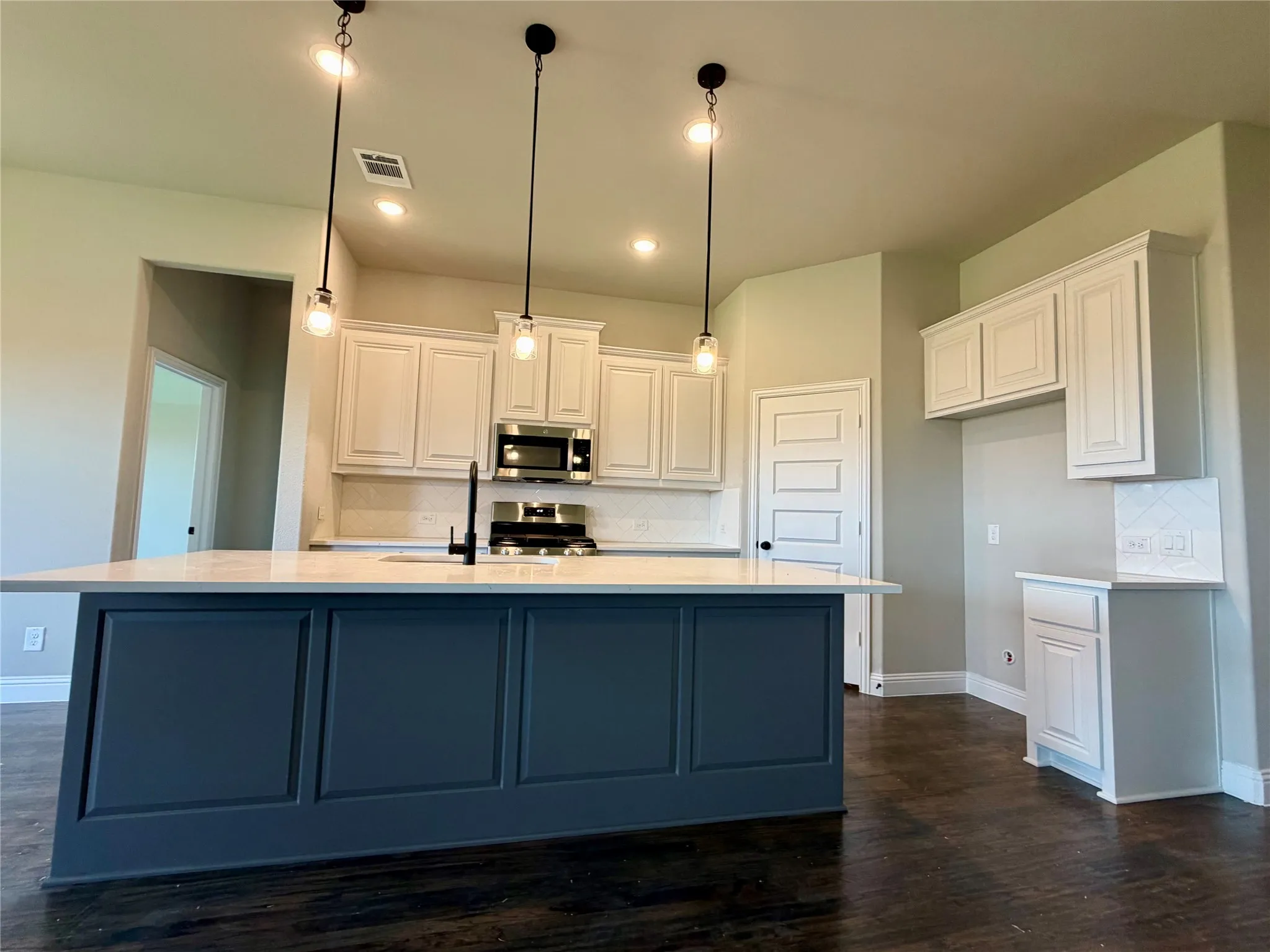 3 Pendant Lights highlight the kitchen island