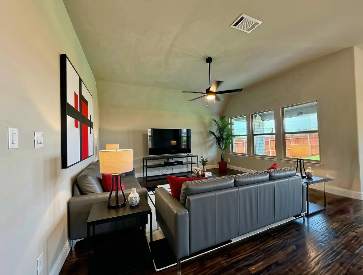 Open and bright family room withrich Ebony hardwood floors and ceiling fan