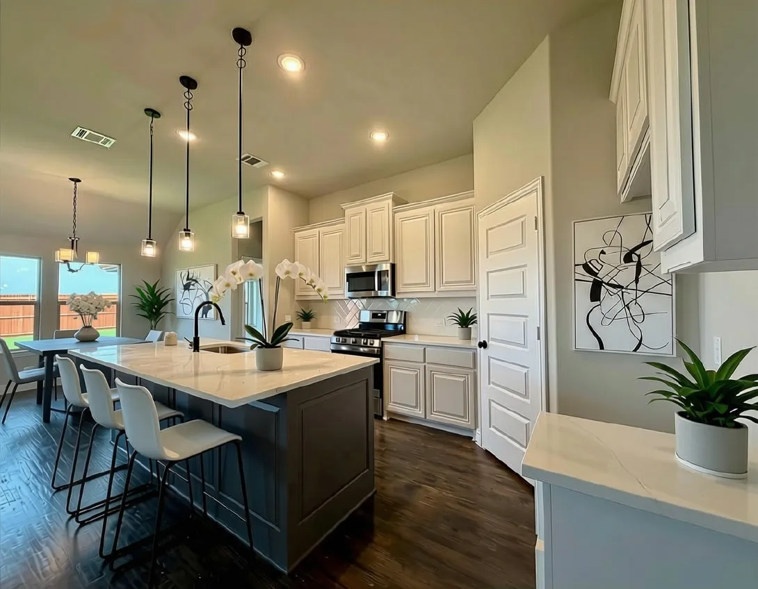 KItchen is modern and inviting featuring a wrapped, Gauntley Grey island that looks like a custom furniture piece