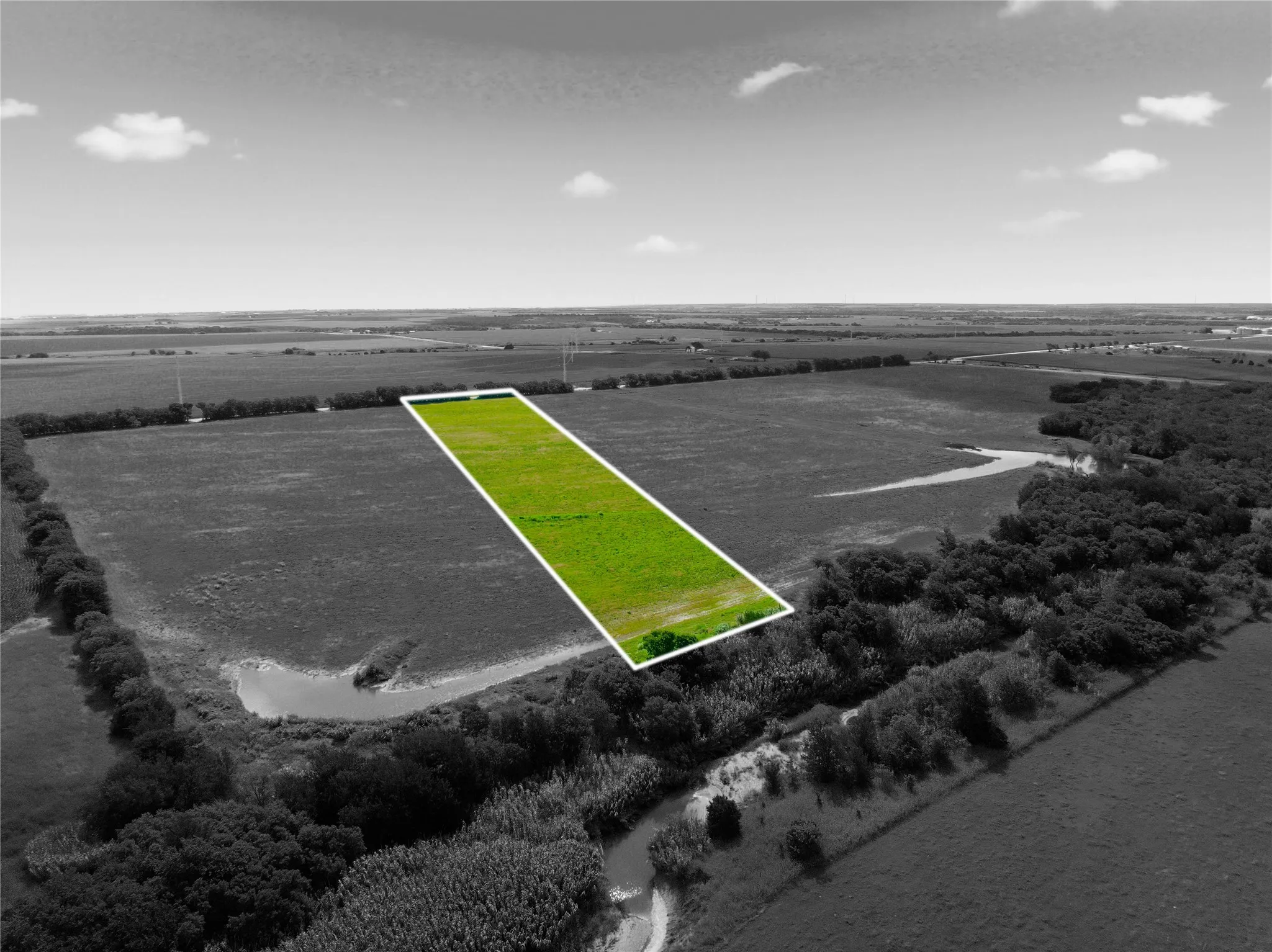 Expansive parcel of land with a rectangular shape, featuring verdant green grass