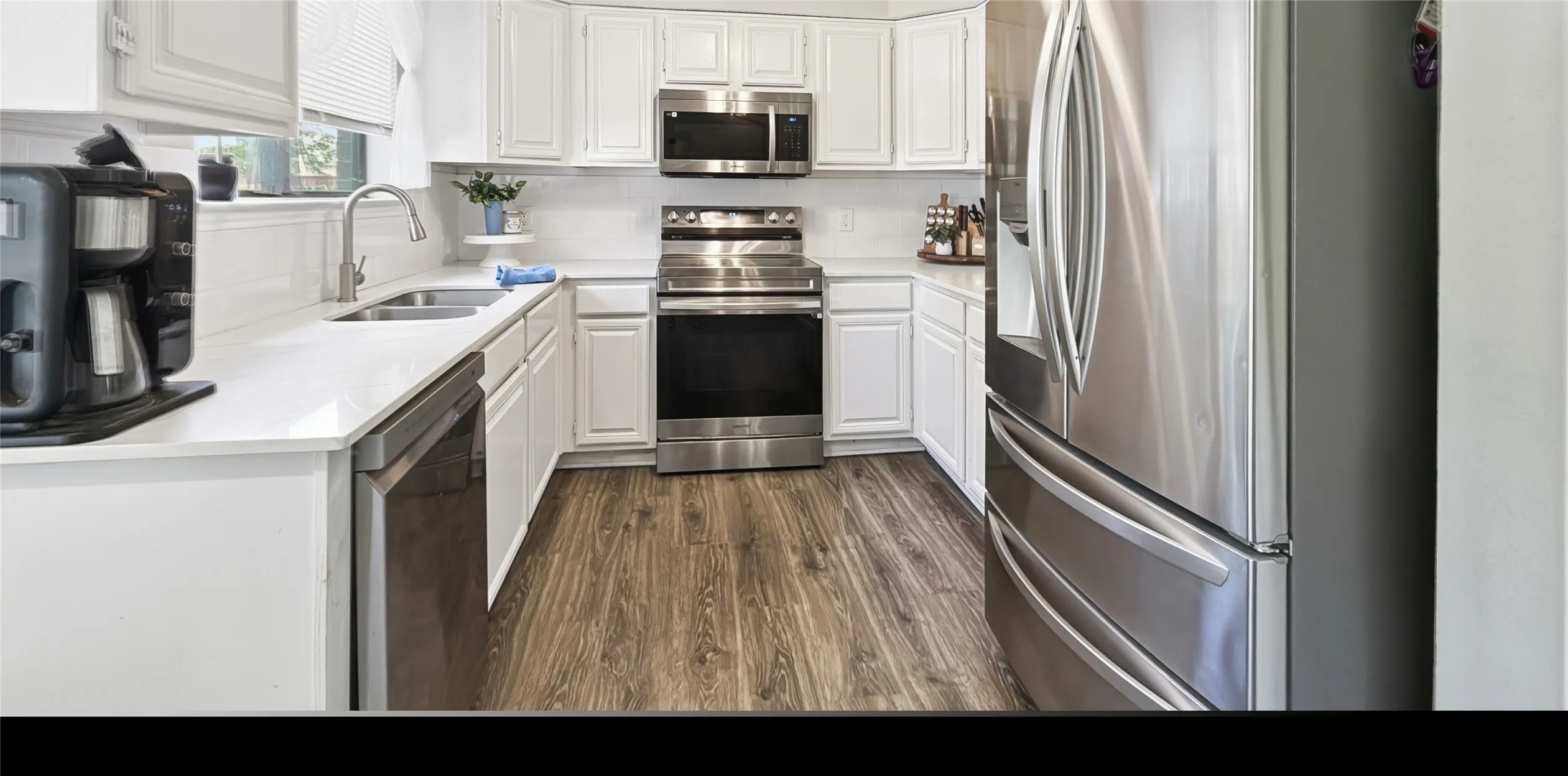 Quartz countertops and stainless steel appliances.