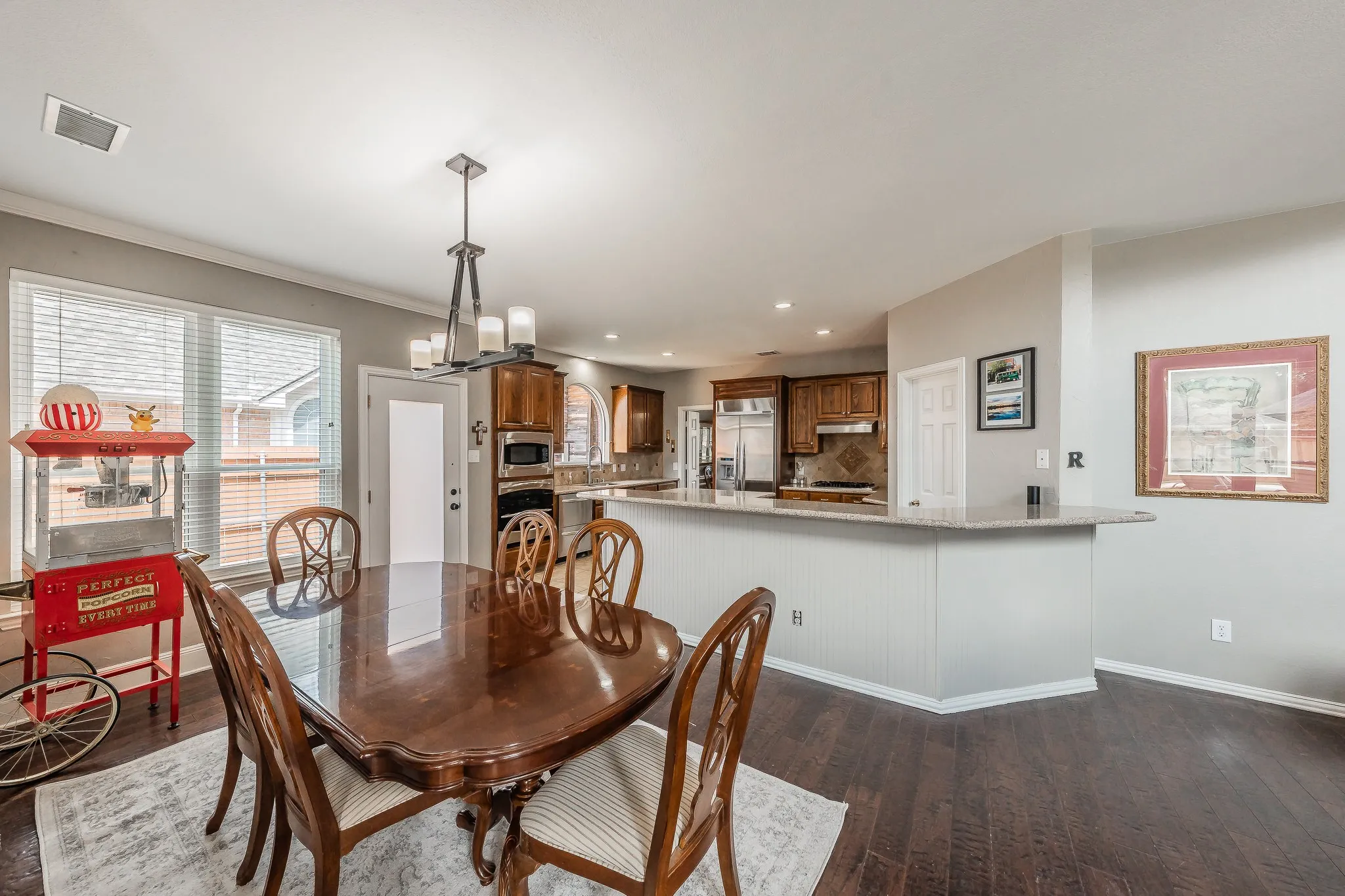 Hardwood-finish flooring extending into the kitchen
