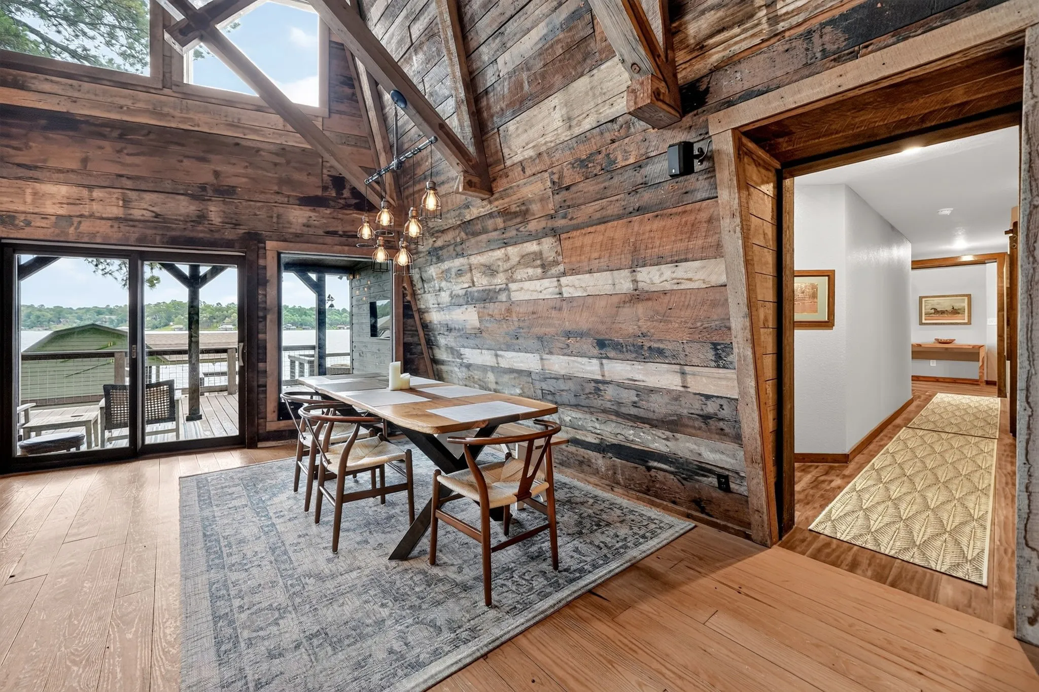 Vaulted ceiling with exposed wood beams and upper windows
