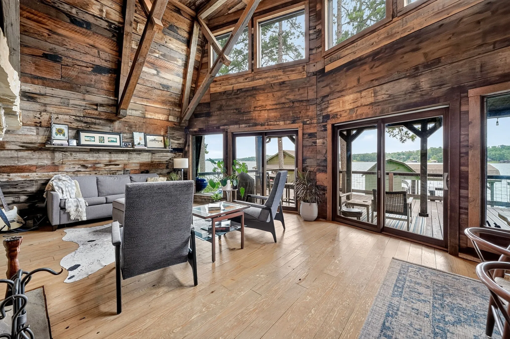 Spacious interior featuring wood-finish flooring and extensive wood plank wall and ceiling finishes