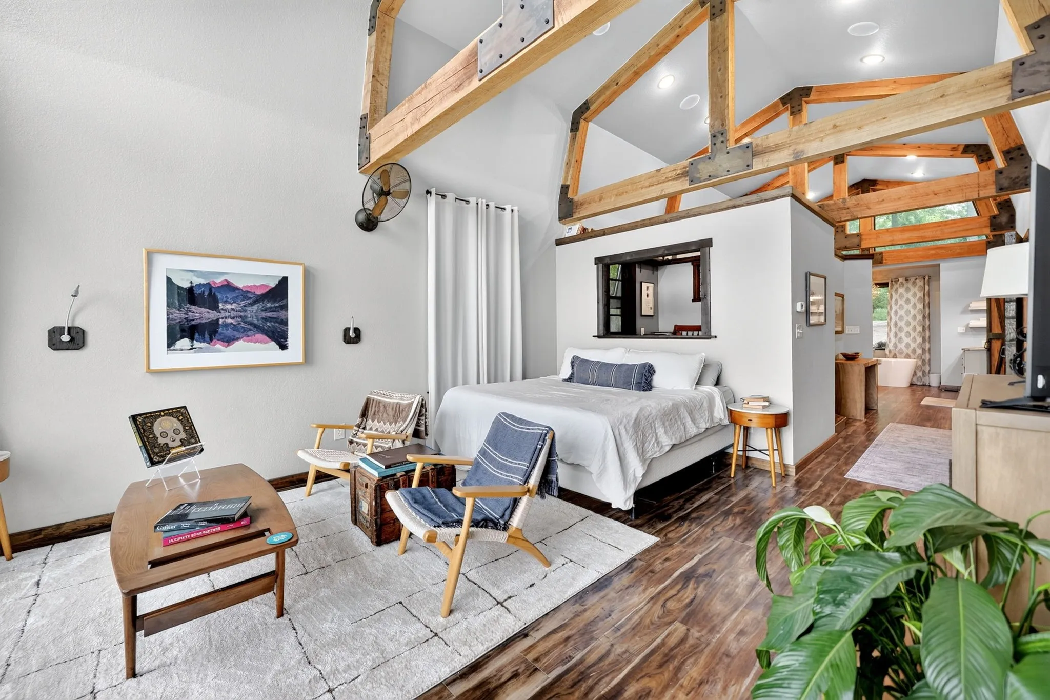Vaulted ceilings featuring exposed wood beams and structural metal brackets