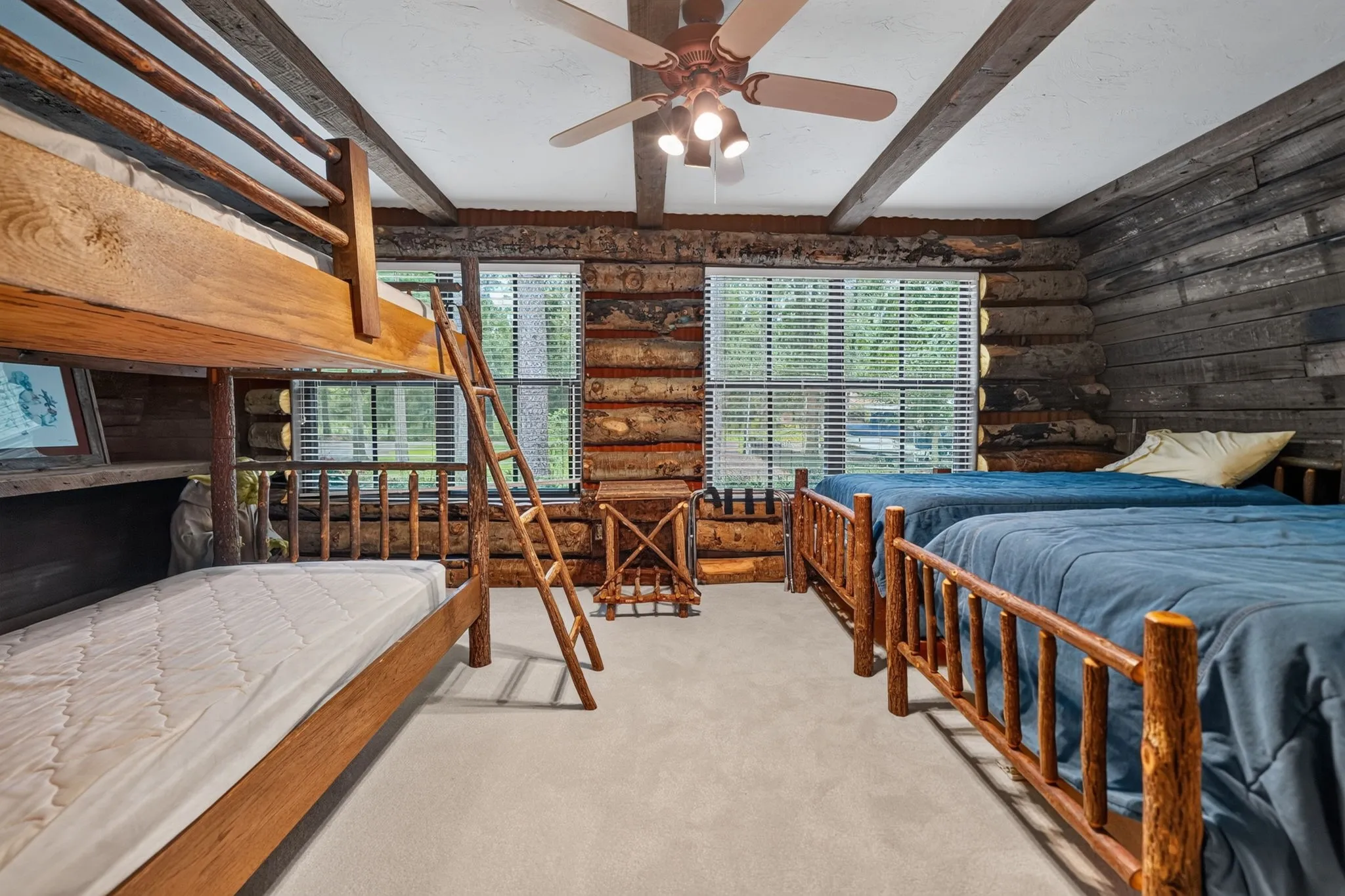 Waterfront room with a beamed wood ceiling and wood-finish flooring