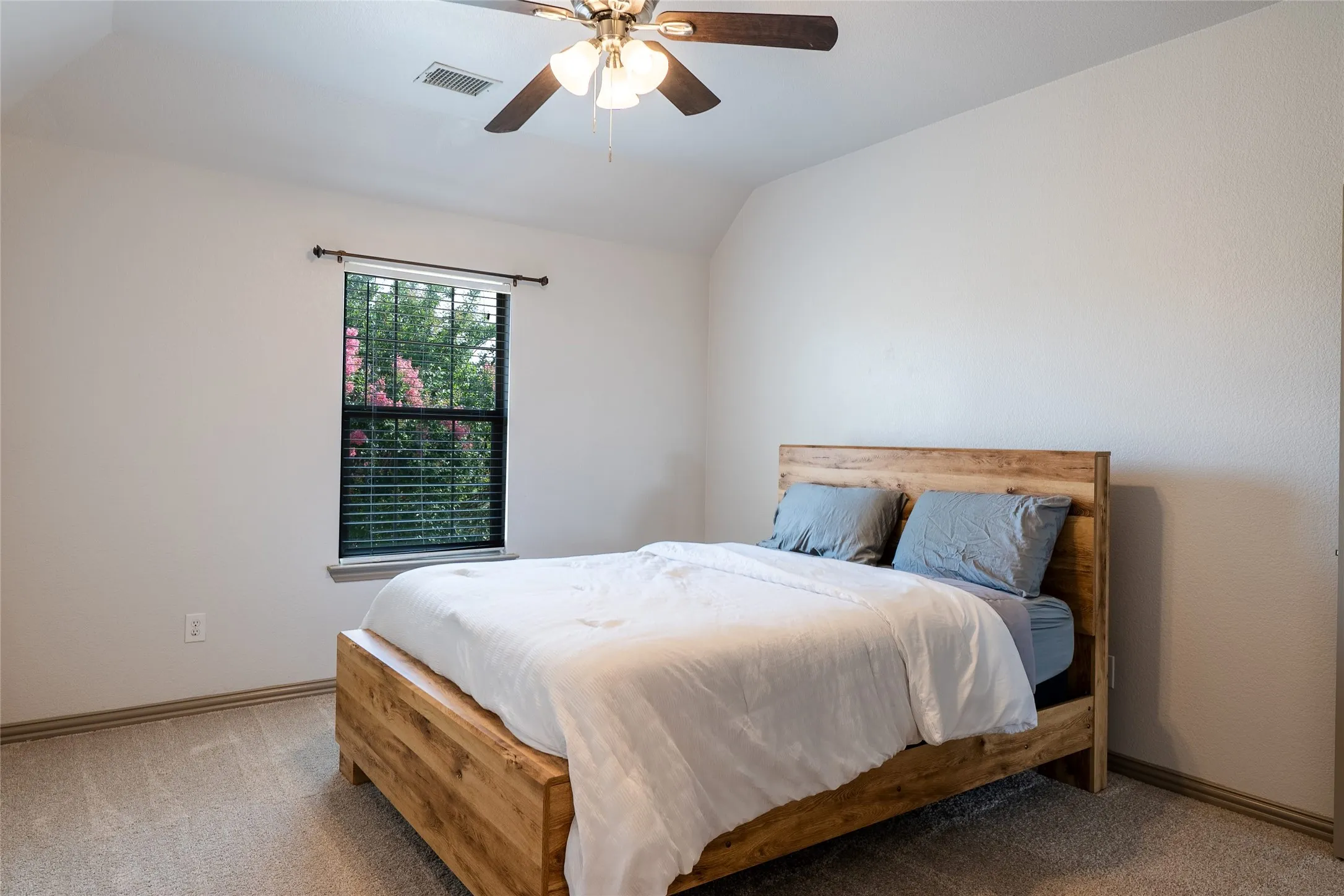 Bright room with a recessed window, ceiling fan, and carpet flooring