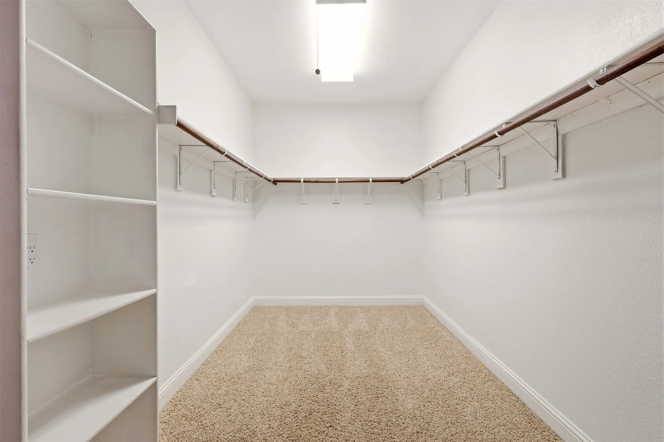 Primary closet with built in drawers and shelves