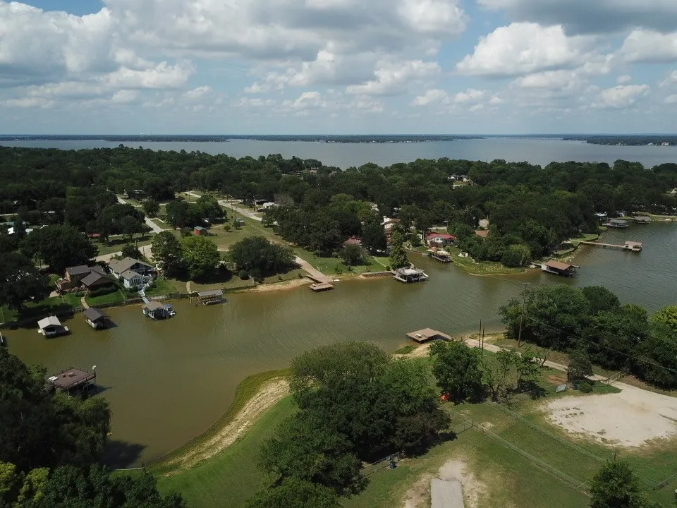 Expansive waterfront property nearby  featuring multiple boat docks and lush surrounding foliage