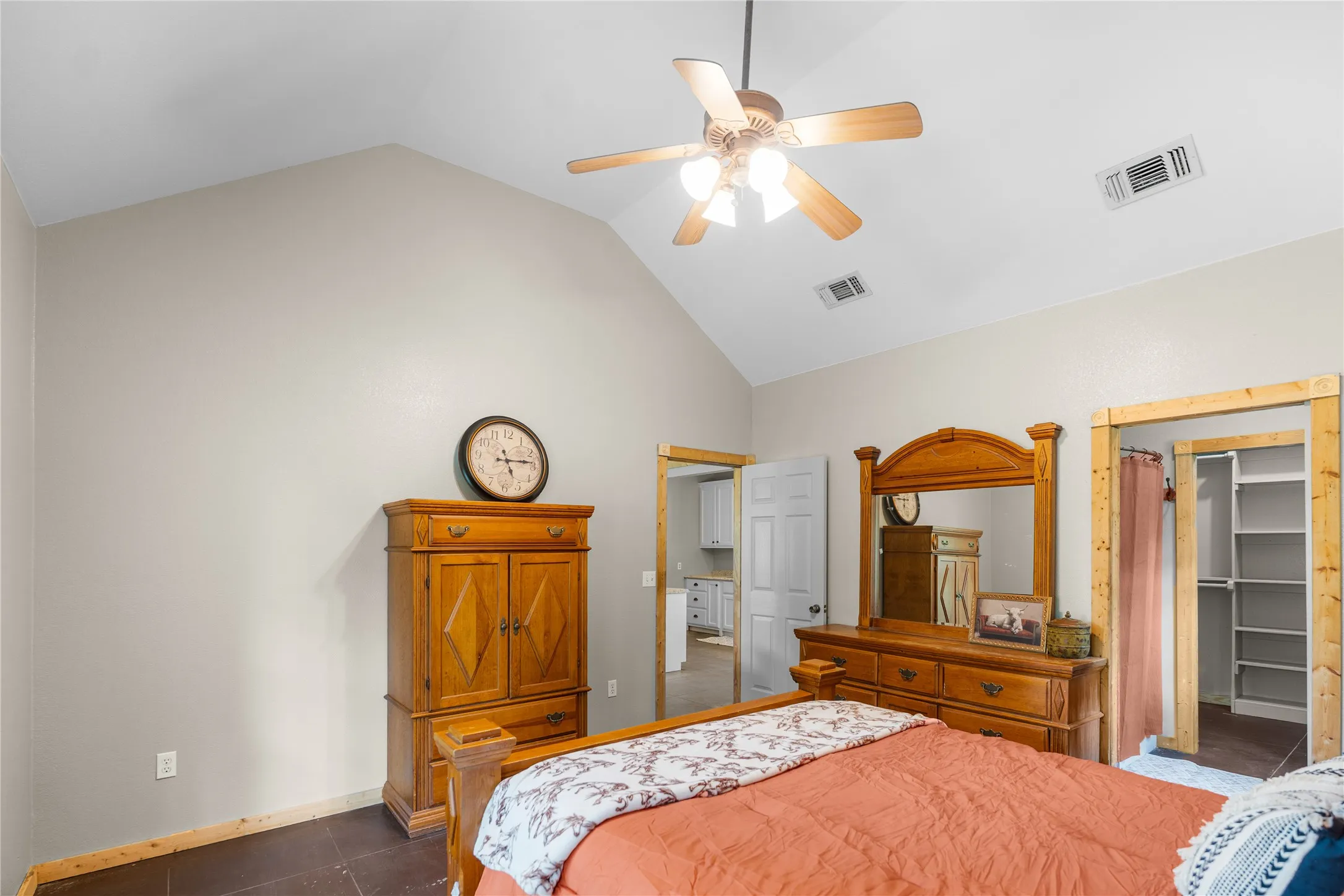 Bedroom featuring a vaulted ceiling and a ceiling fan with integrated lighting