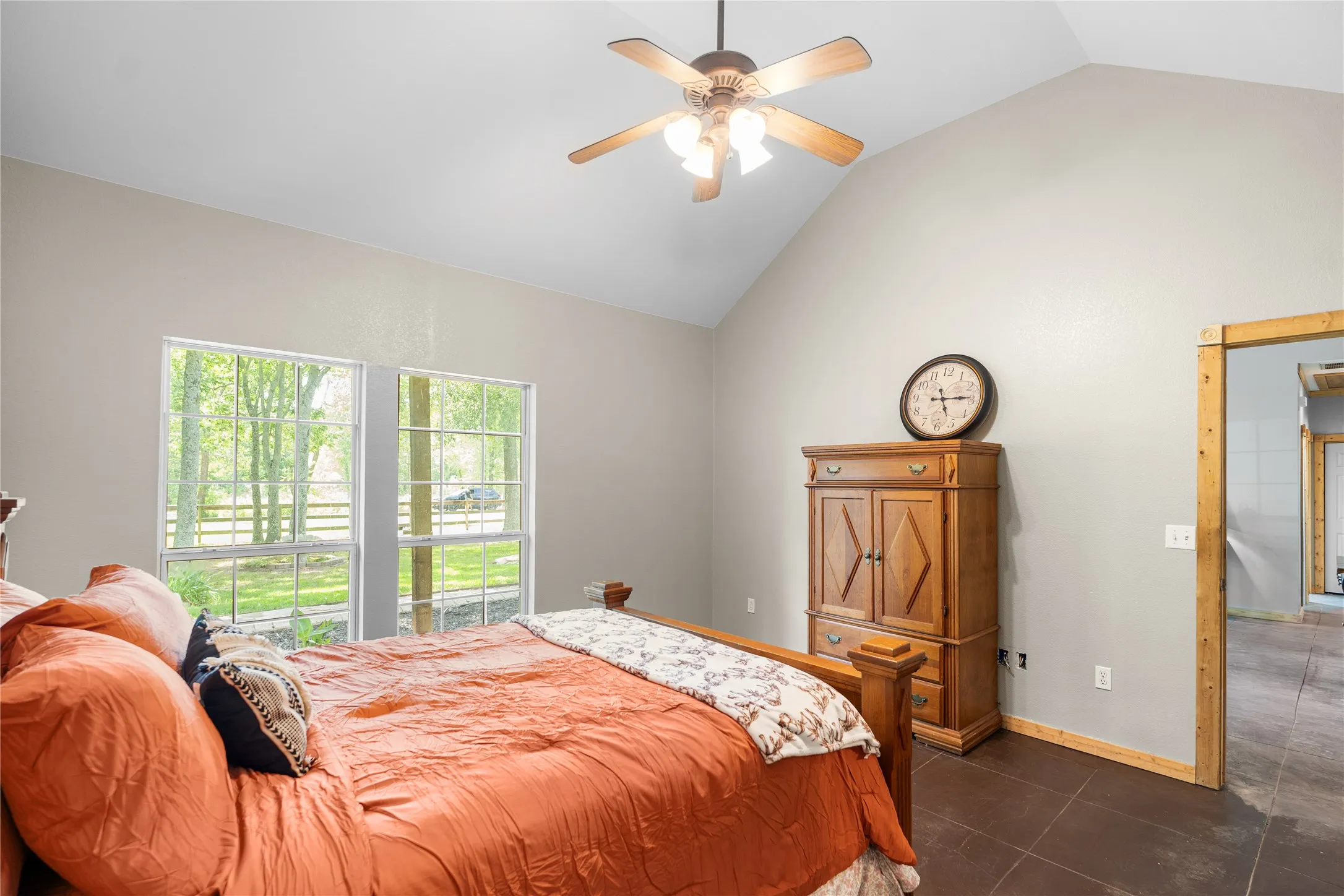 Vaulted ceiling bedroom with dual-pane windows, providing abundant natural light