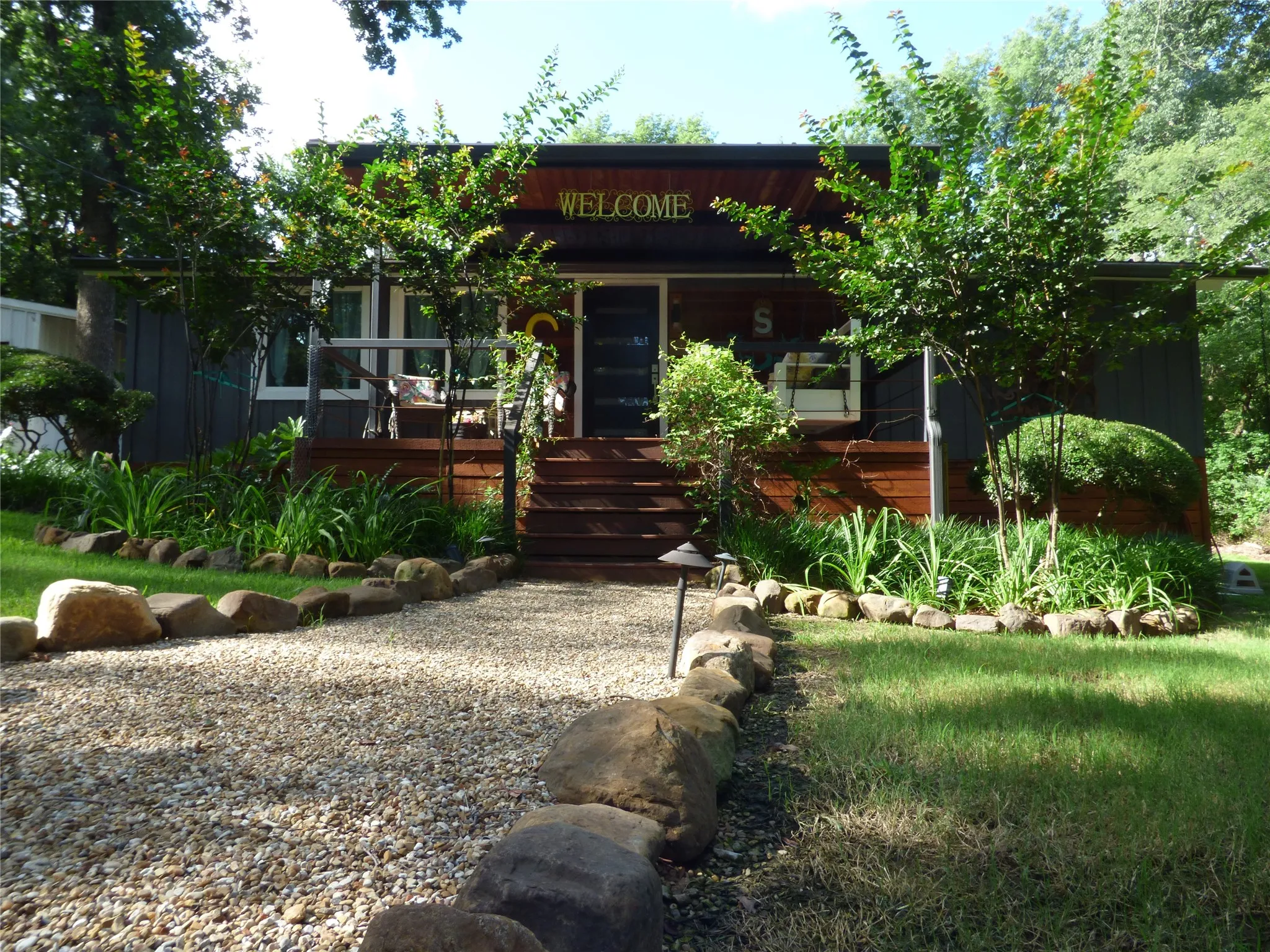 Charming exterior featuring dark siding and natural wood accents