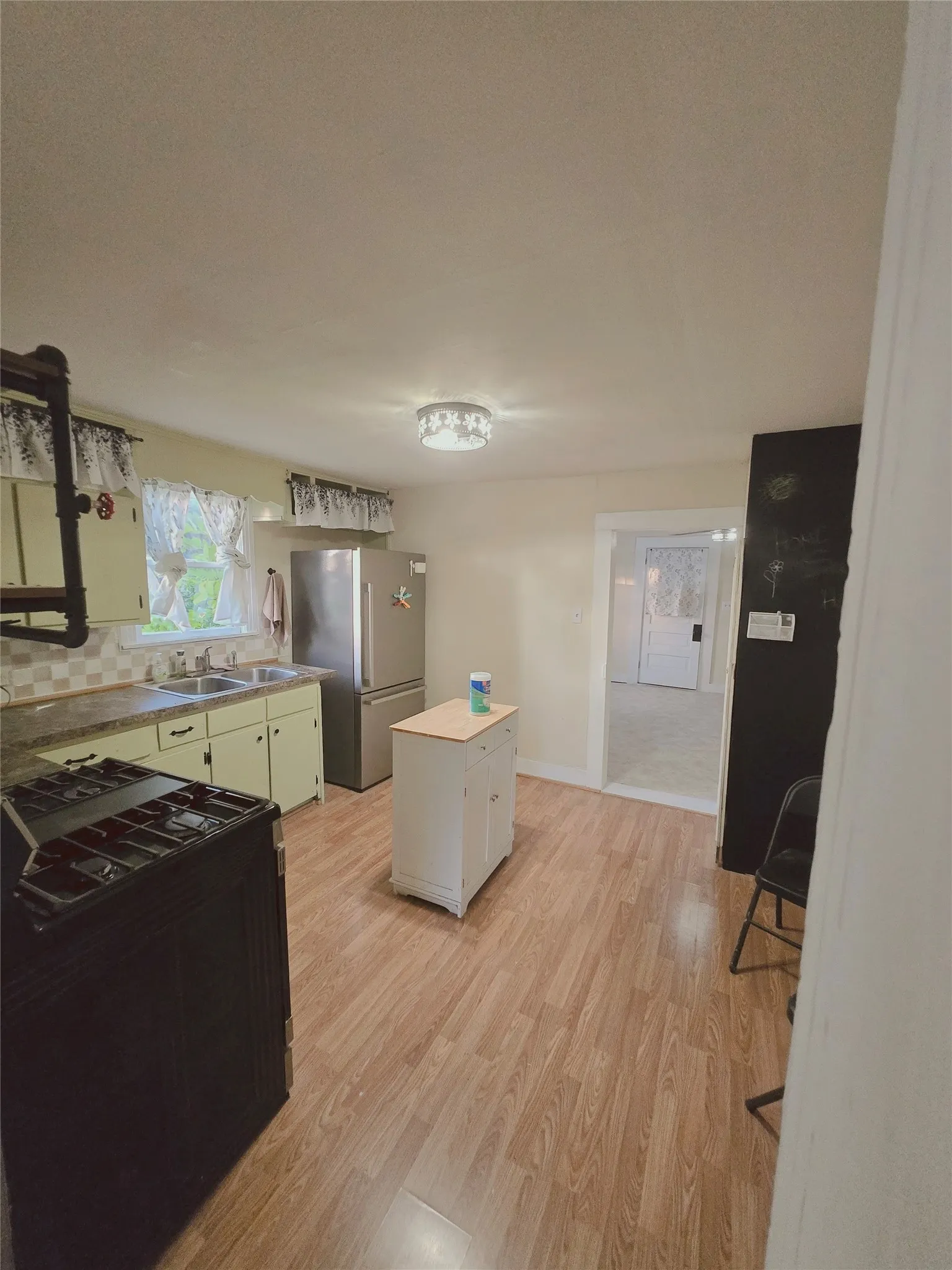 Functional kitchen with ample counter space and durable flooring awaits culinary creativity.