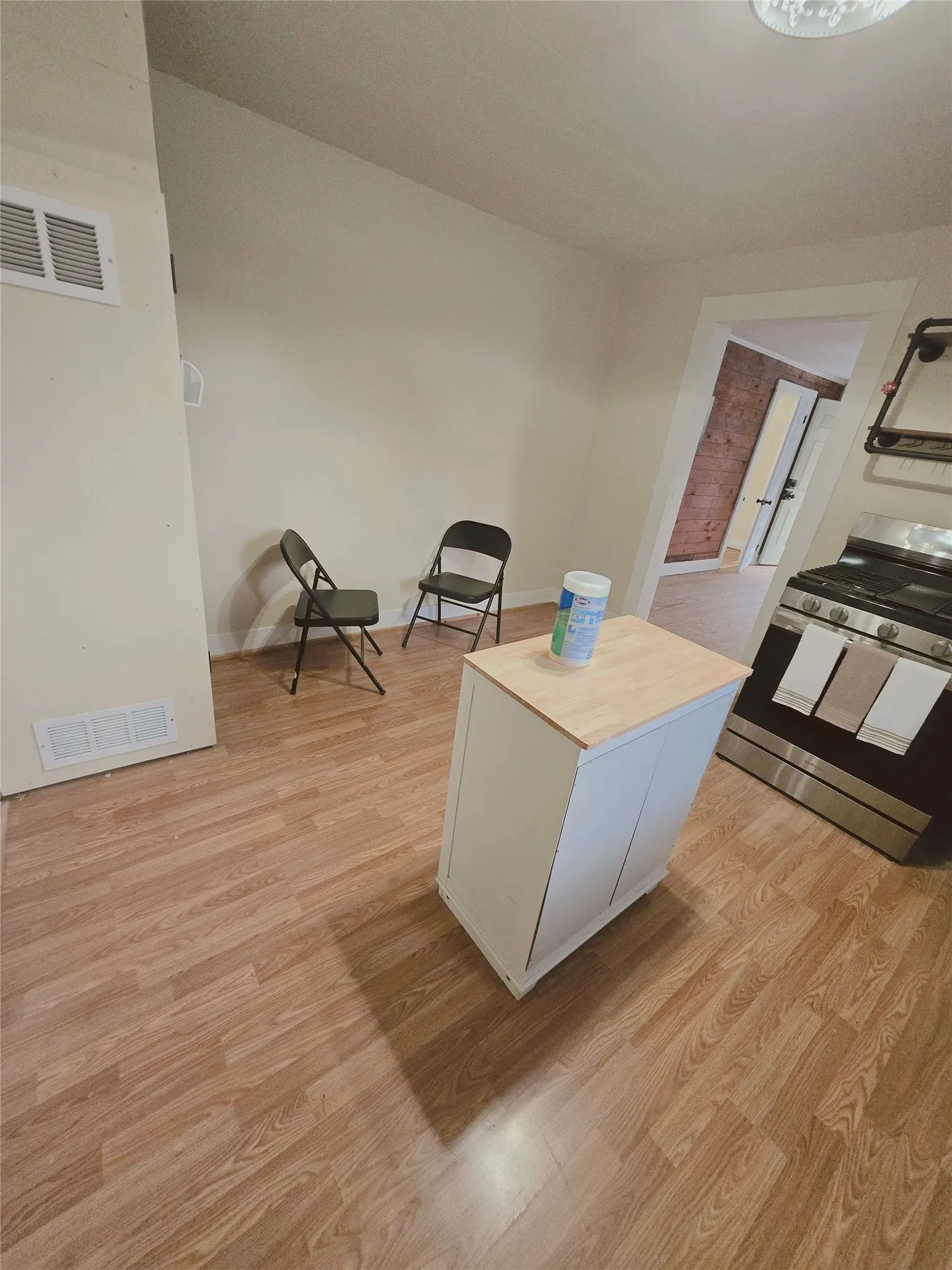 A compact kitchen with sleek appliances and practical flooring.