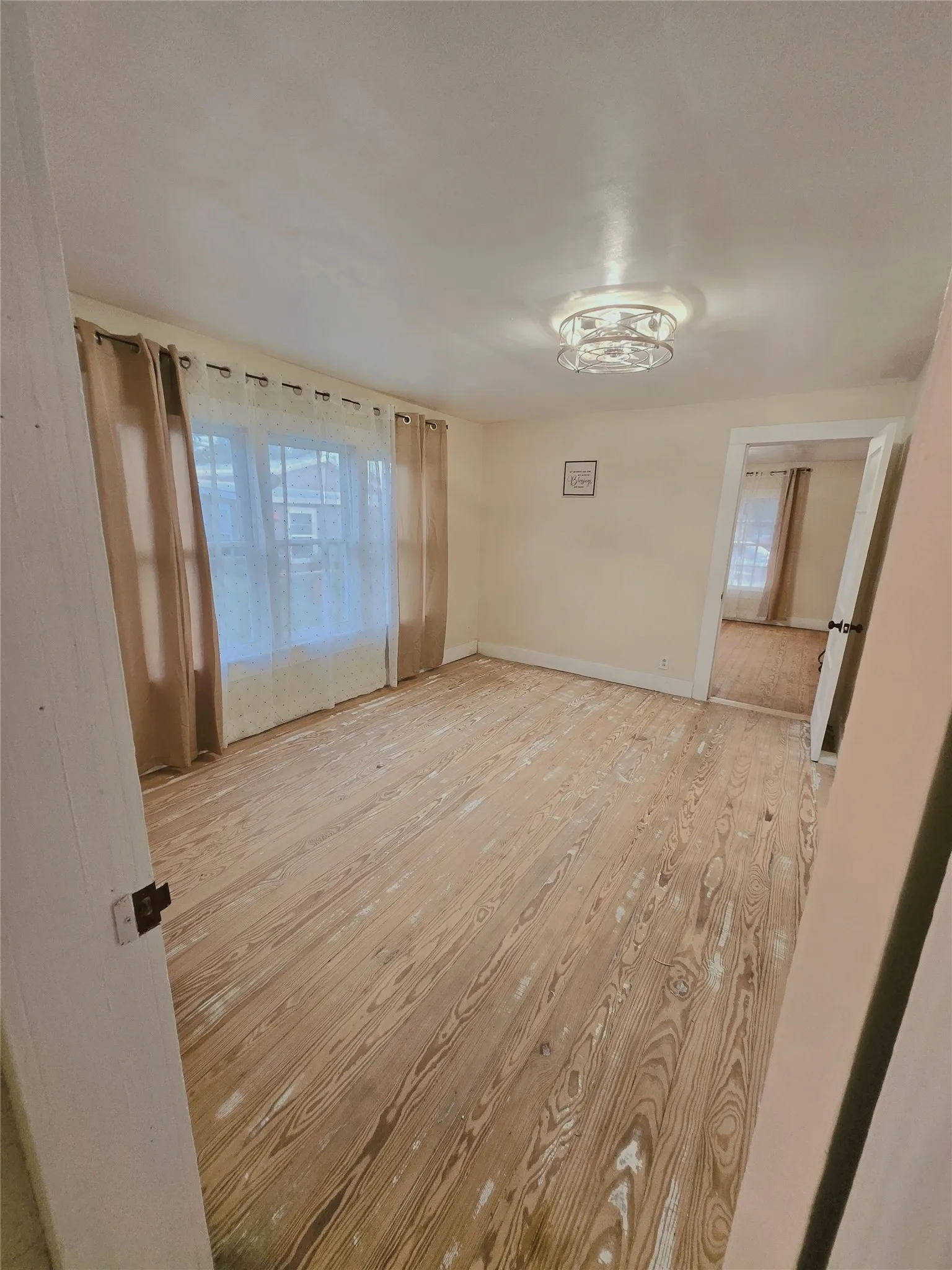 Natural light illuminates the authentic hardwood floors, creating a warm, inviting atmosphere.