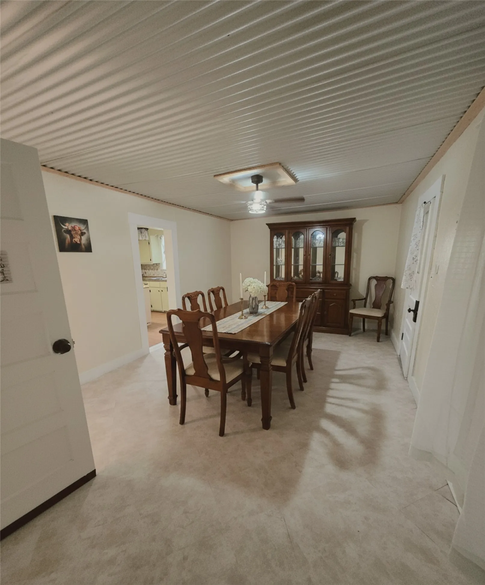 A well-proportioned dining room ready for gatherings, featuring a classic dining set and ample space. DIGITAL STAGING