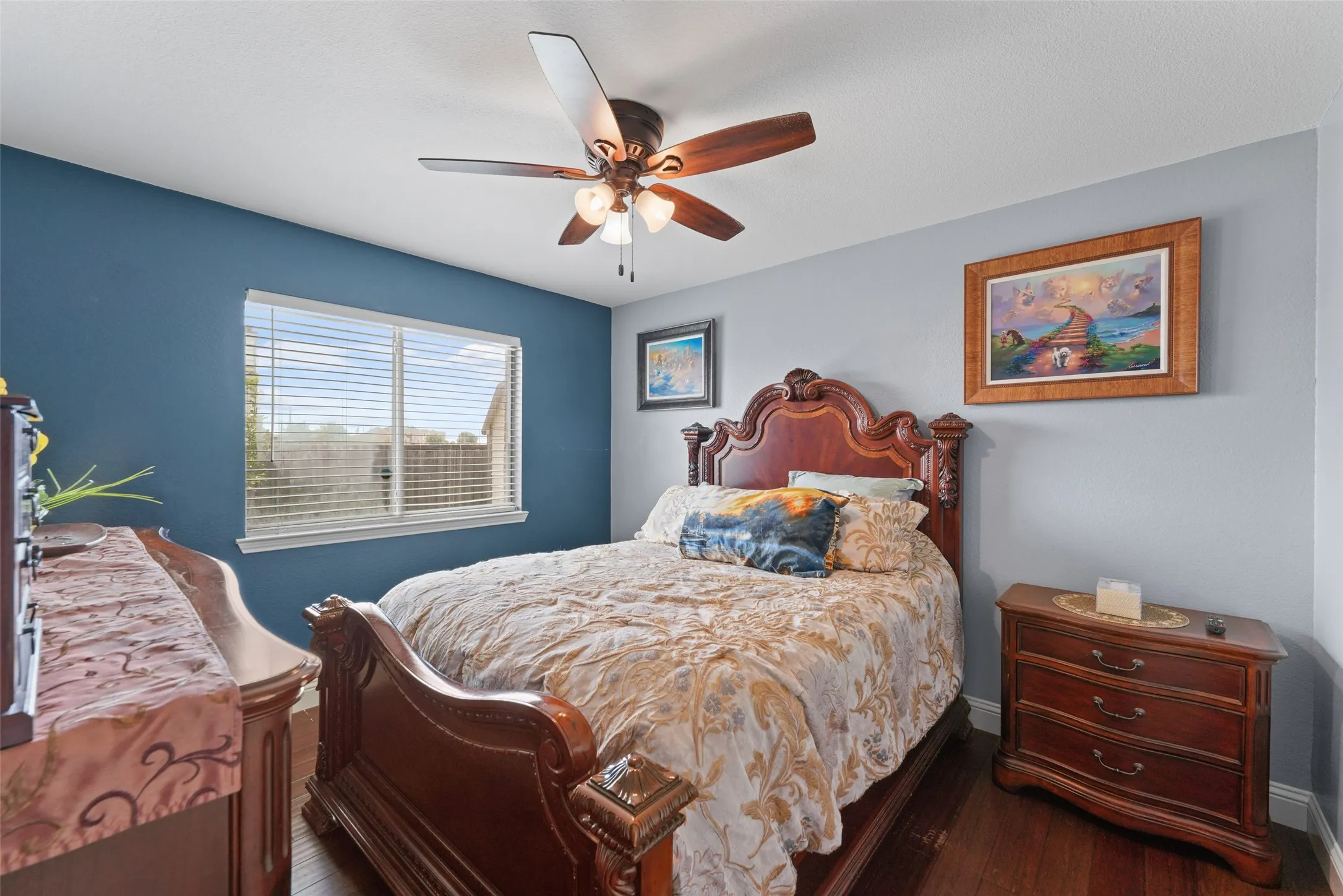 Interior room featuring wood-finish flooring, a ceiling fan with integrated lighting, and a window with horizontal blinds
