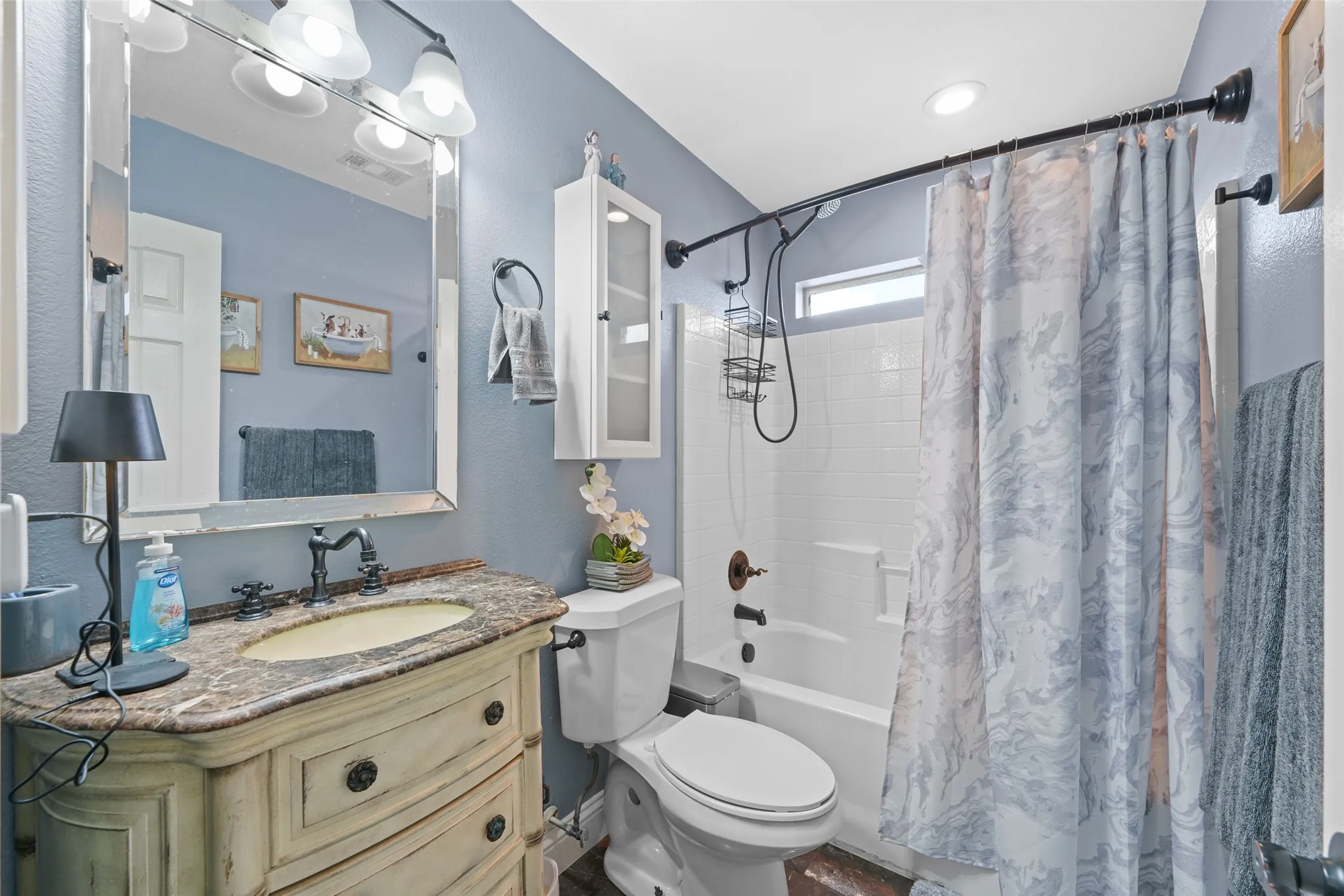 Bathroom featuring a vanity with a stone countertop, an oval sink, and a decorative faucet