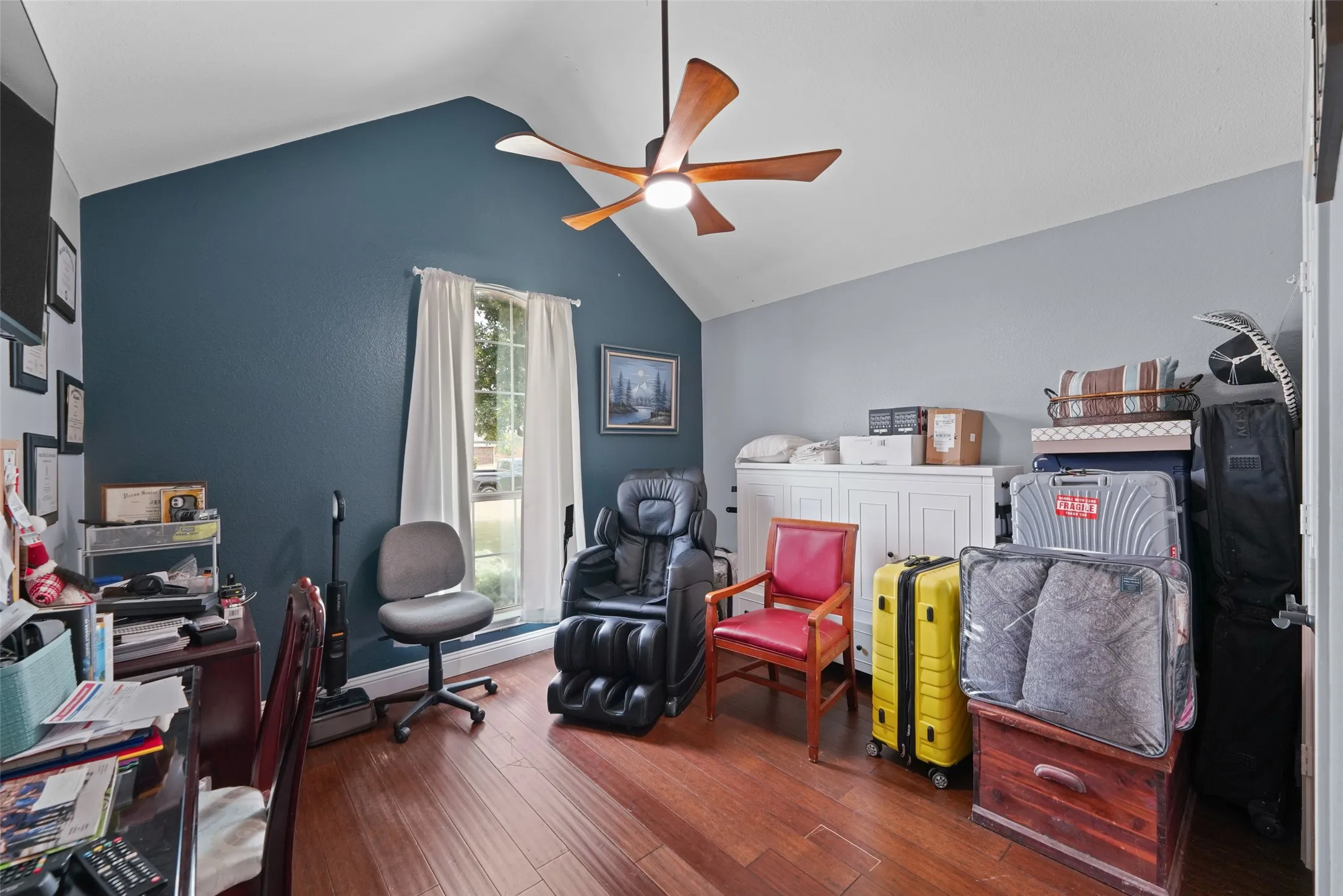 Room featuring wood-finish flooring and a vaulted ceiling