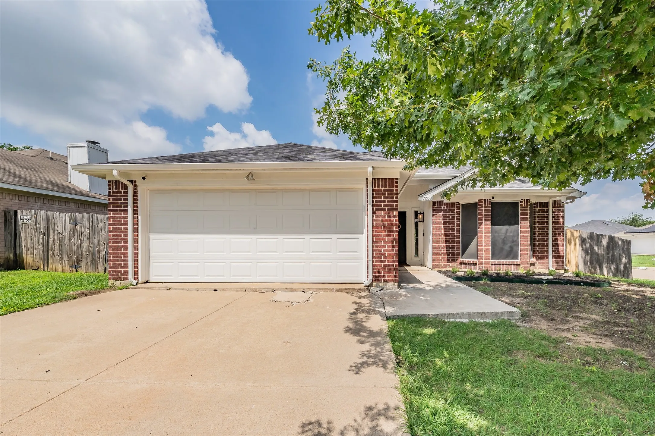 Brick exterior with an attached two-car garage