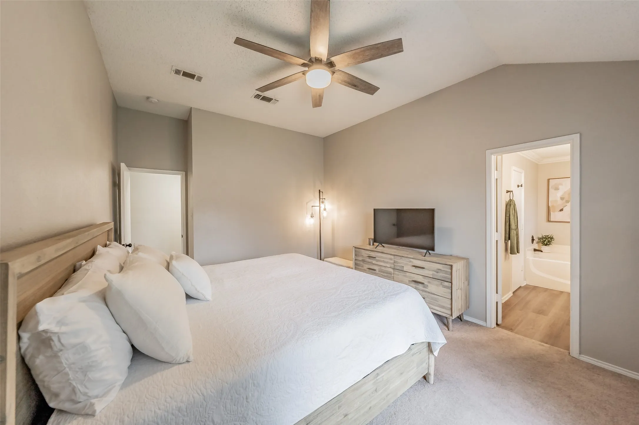 Primary bedroom featuring neutral wall paint, and carpet flooring