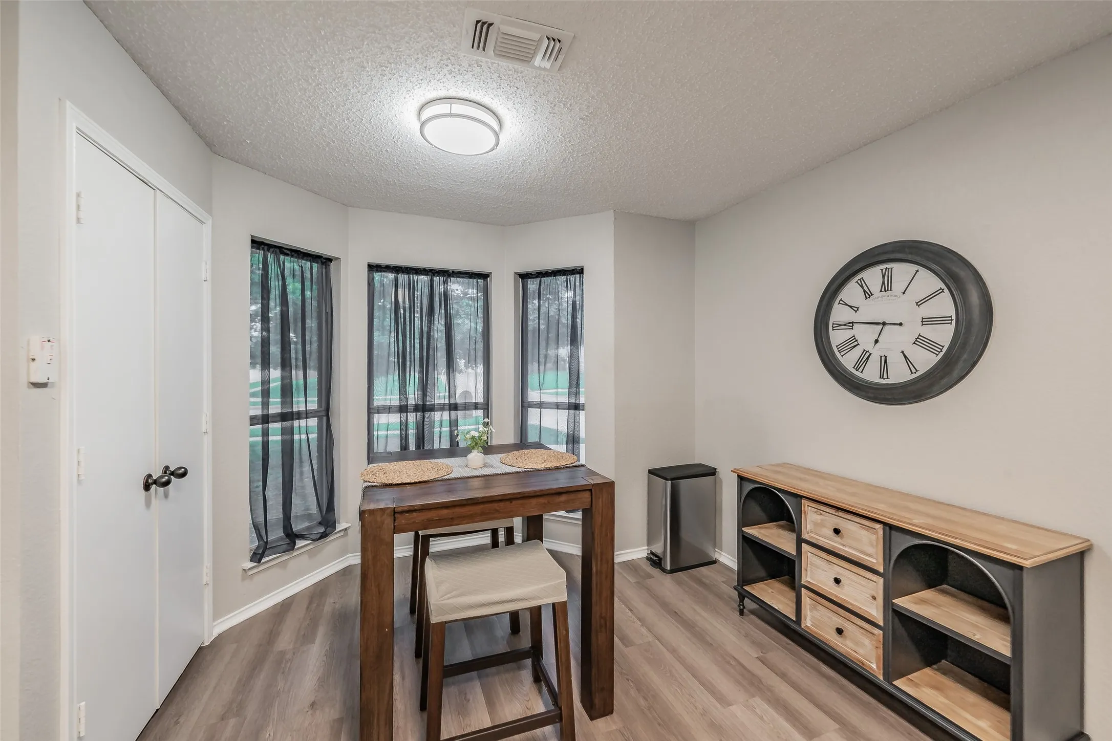 Dining area featuring a bay window, and a contemporary flush-mount ceiling light